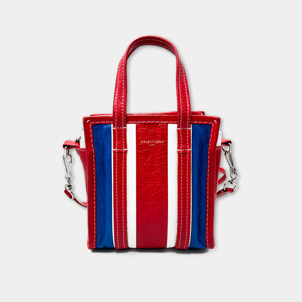 A red, white, and blue striped handbag with the Balenciaga logo on it.