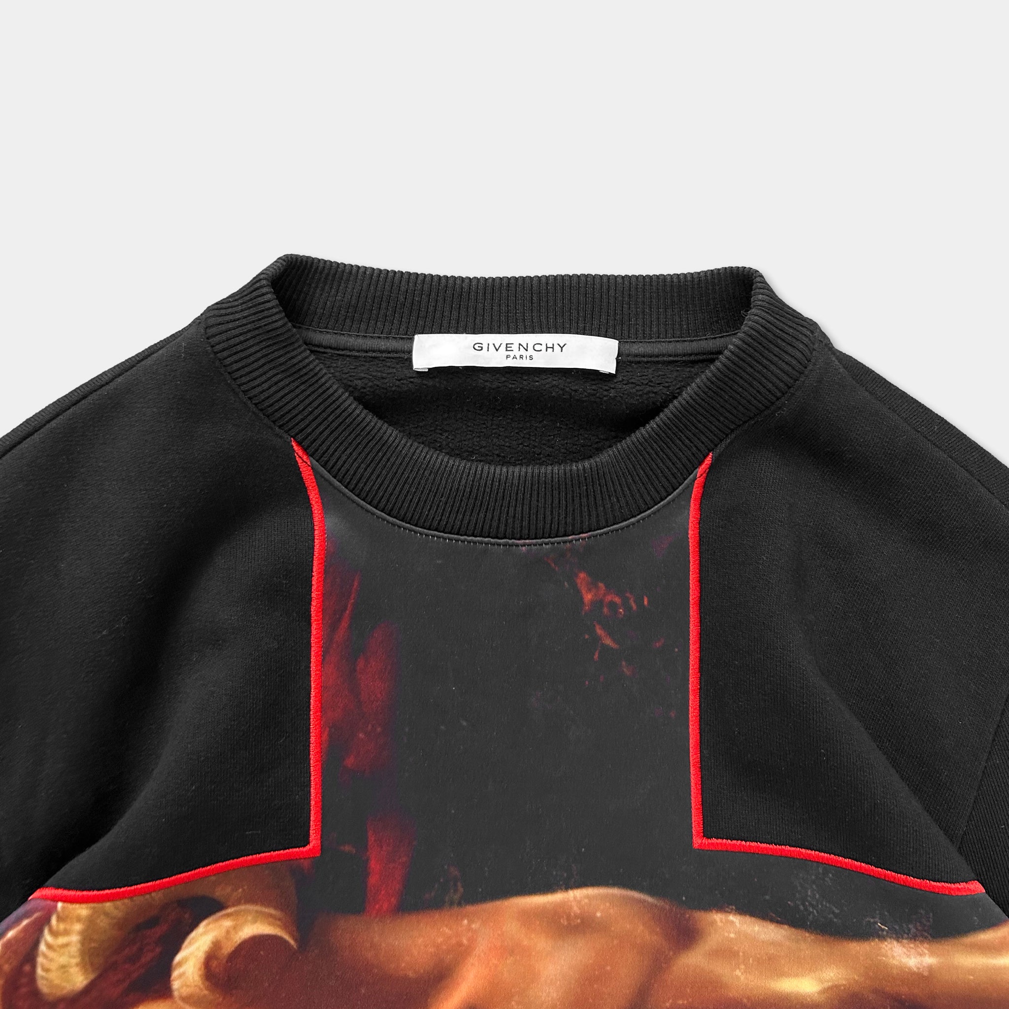 a black and red sweatshirt with a graphic design on the front.