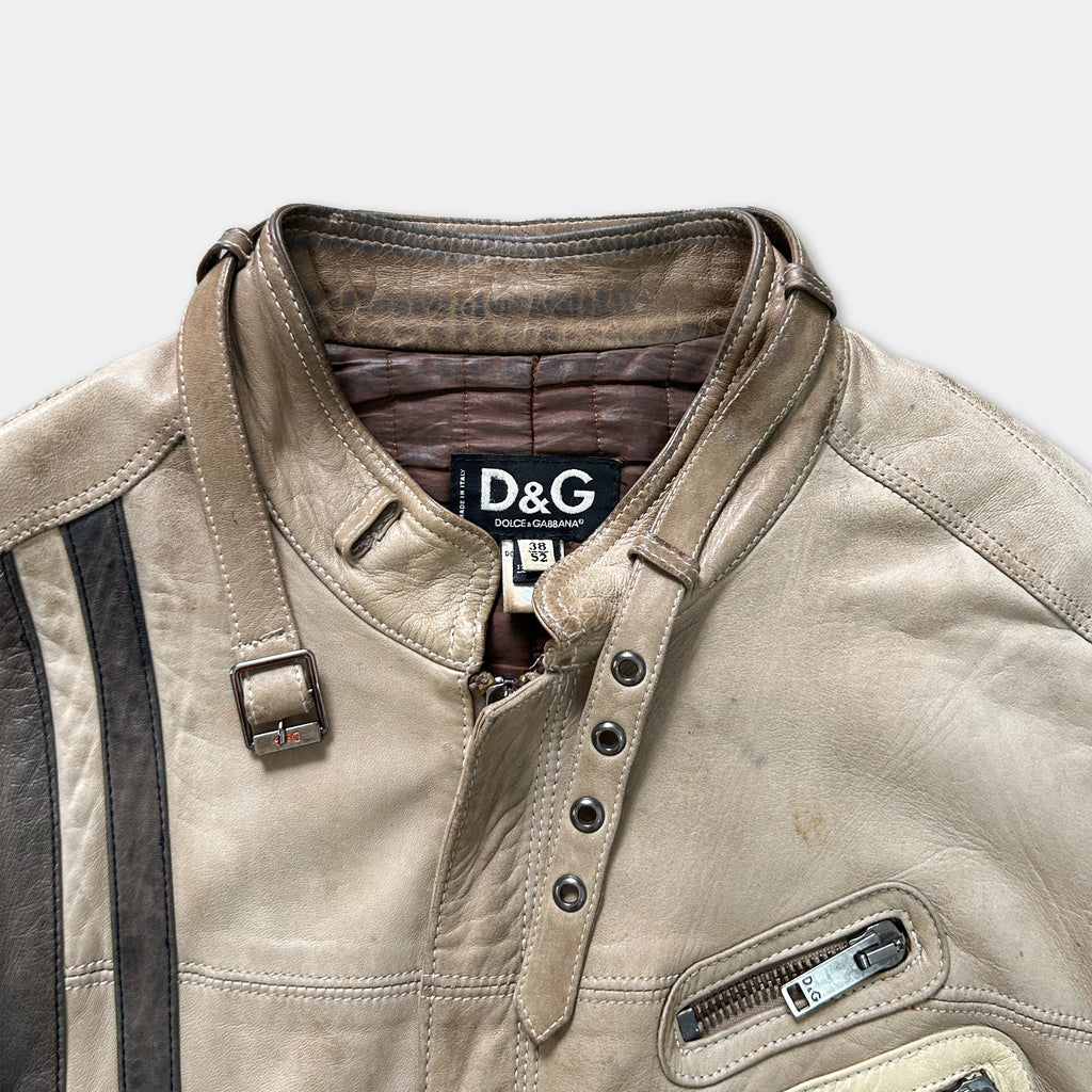 A tan leather jacket with a brown collar and a D&G logo on the chest.