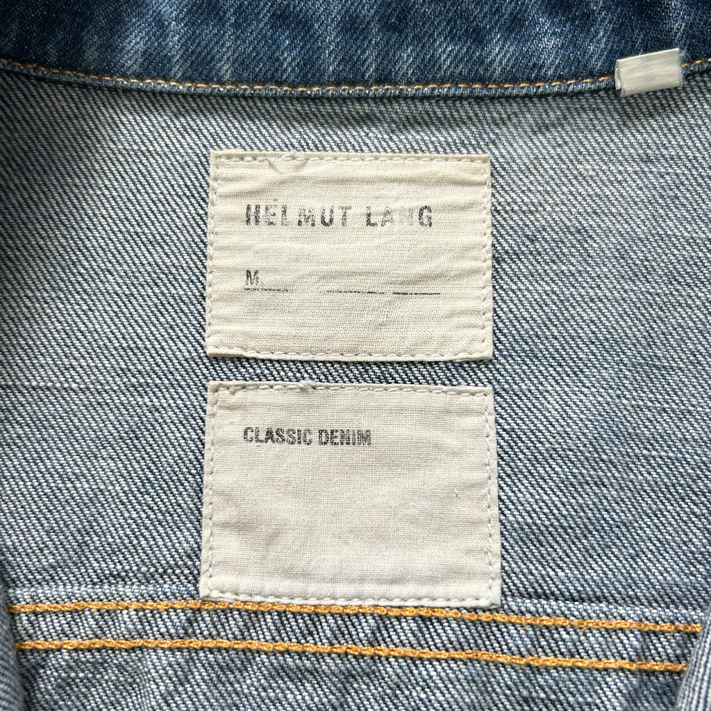 a close-up view of a denim fabric, specifically a pair of jeans, with two labels attached to it.