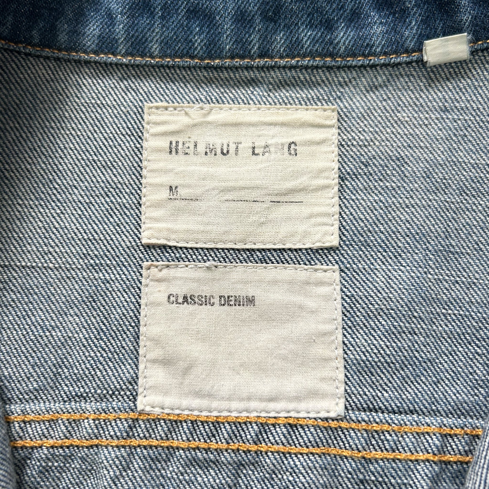 a close-up view of a denim fabric, specifically a pair of jeans, with two labels attached to it.