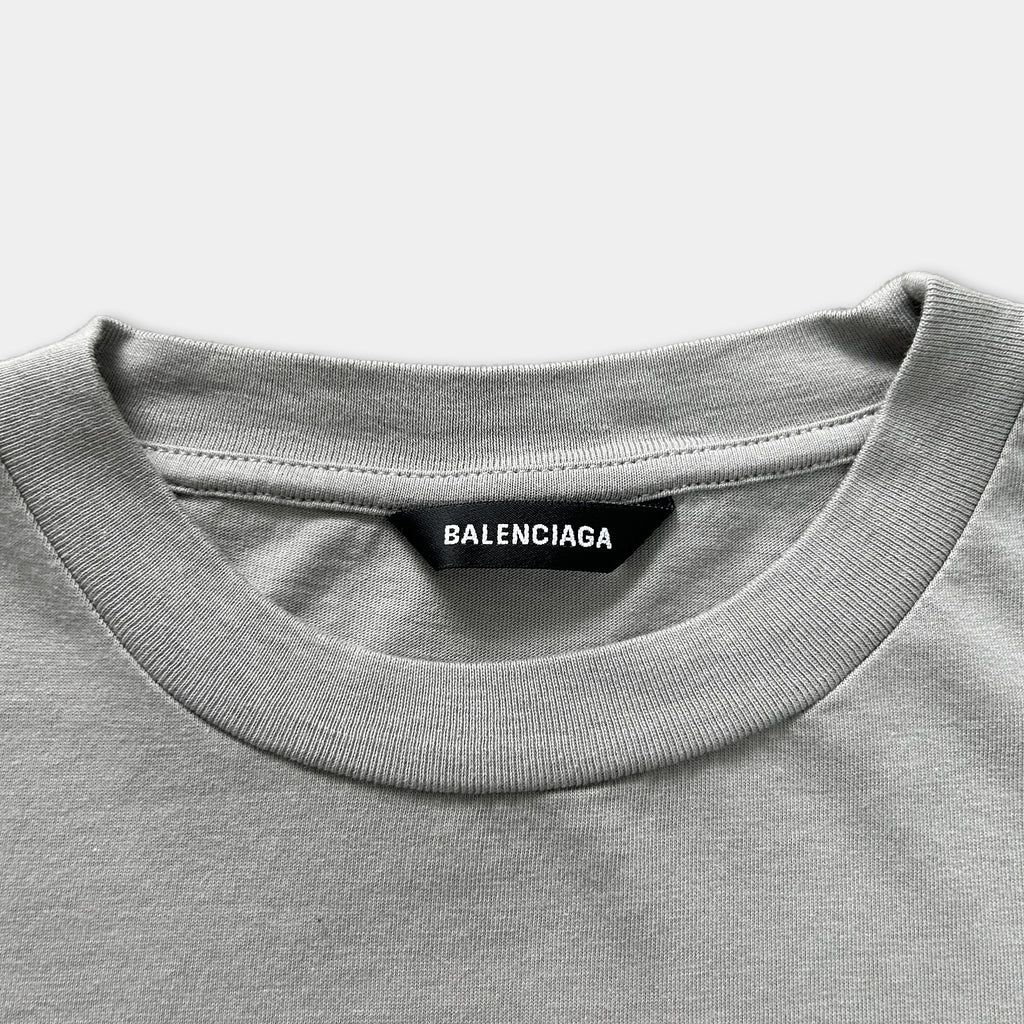 A gray t-shirt with a black label that reads "BALENCIA".