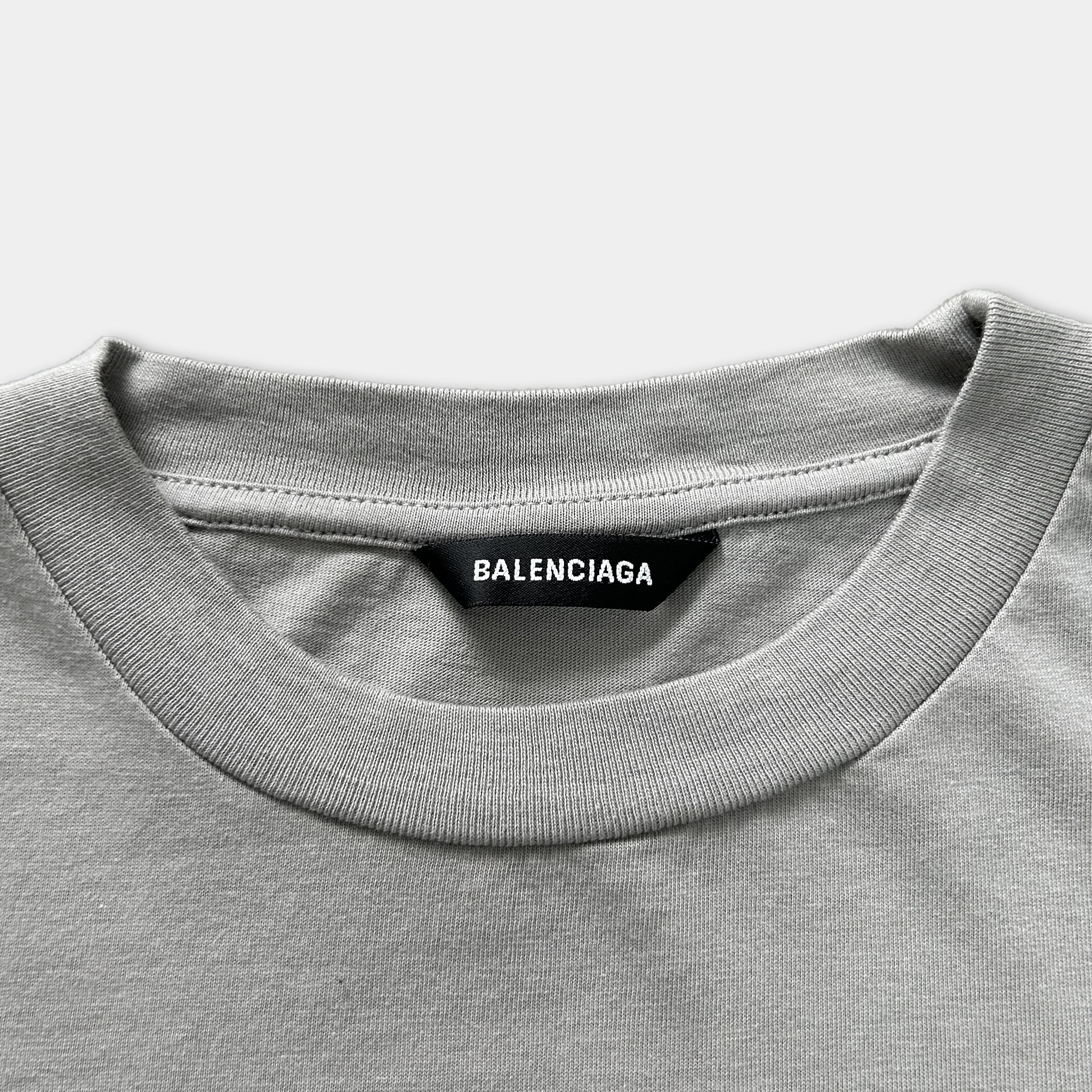 A gray t-shirt with a black label that reads "BALENCIA".