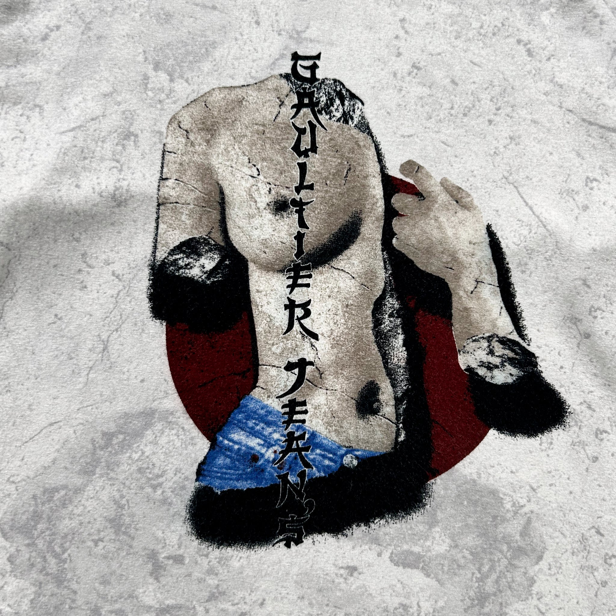 The image is a stylized representation of a human figure, possibly a nude or partially nude figure, with text overlaying the image. The text appears to be in a foreign language, adding an element of intrigue and cultural context to the composition.