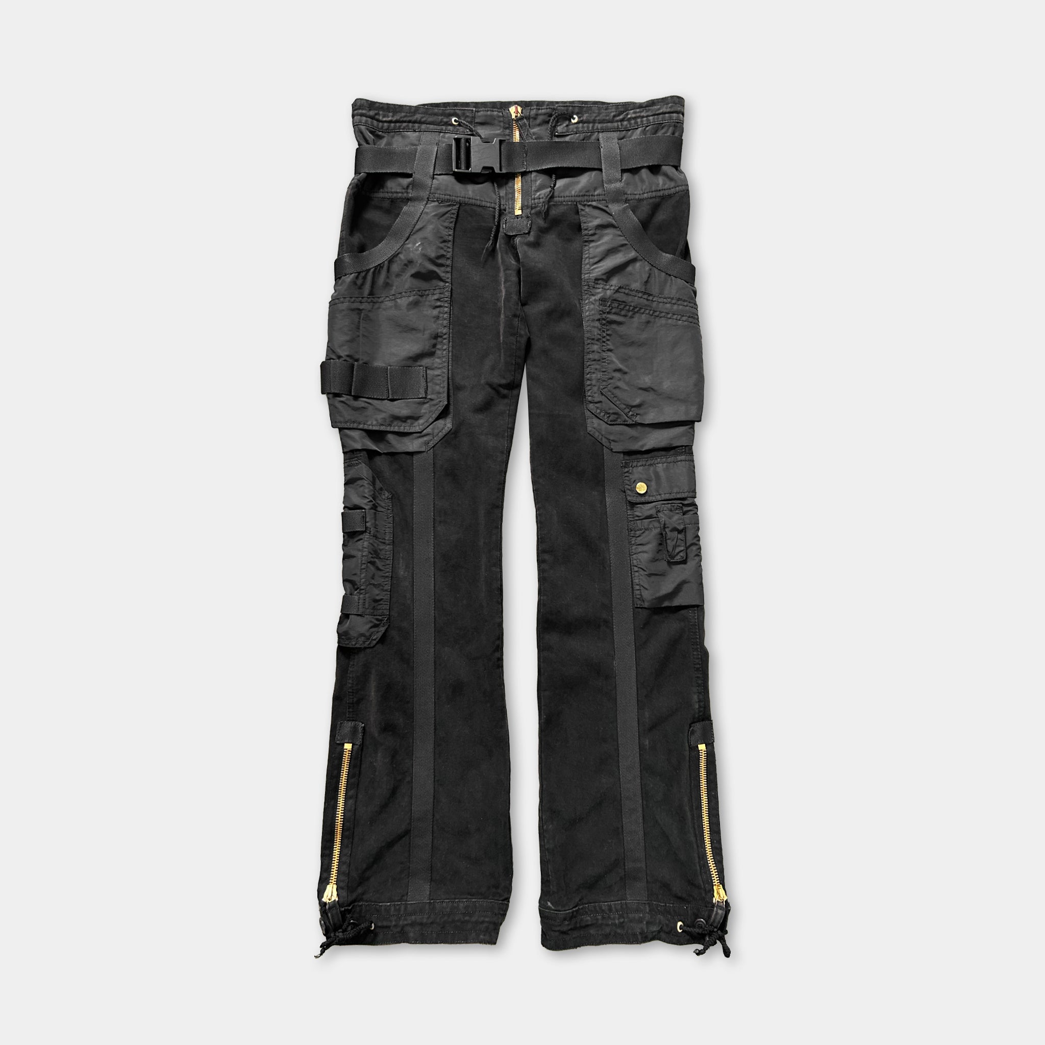 A pair of black cargo pants with multiple pockets and zippers.