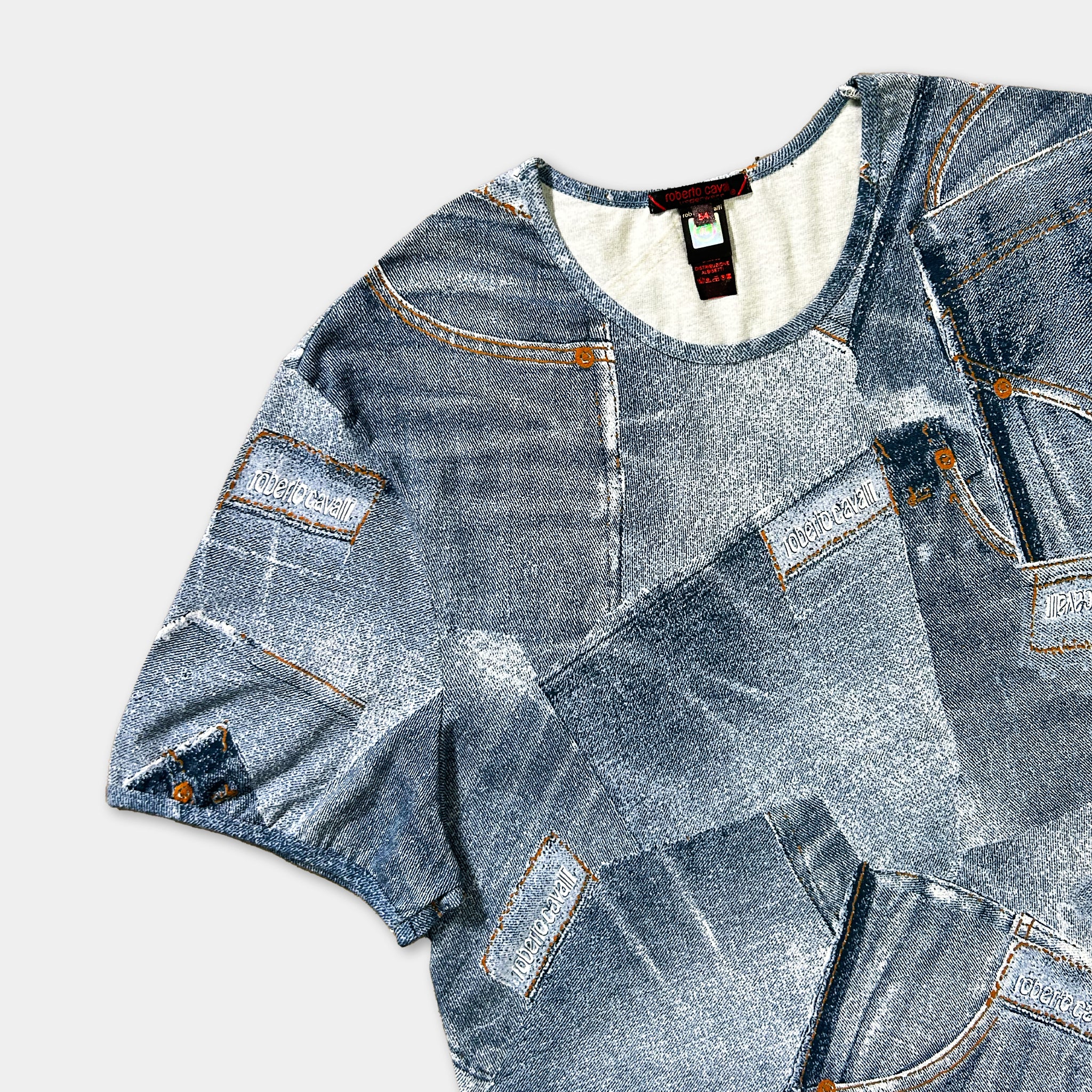 a t-shirt with a denim-inspired design, including various shades of blue denim fabric and pockets.
