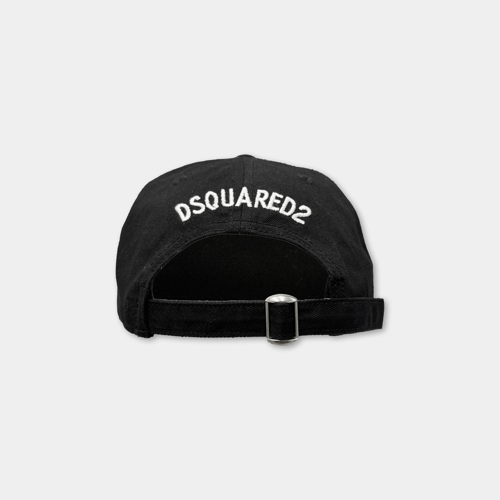 A black baseball cap with the logo "DSQUARED2" printed on it.