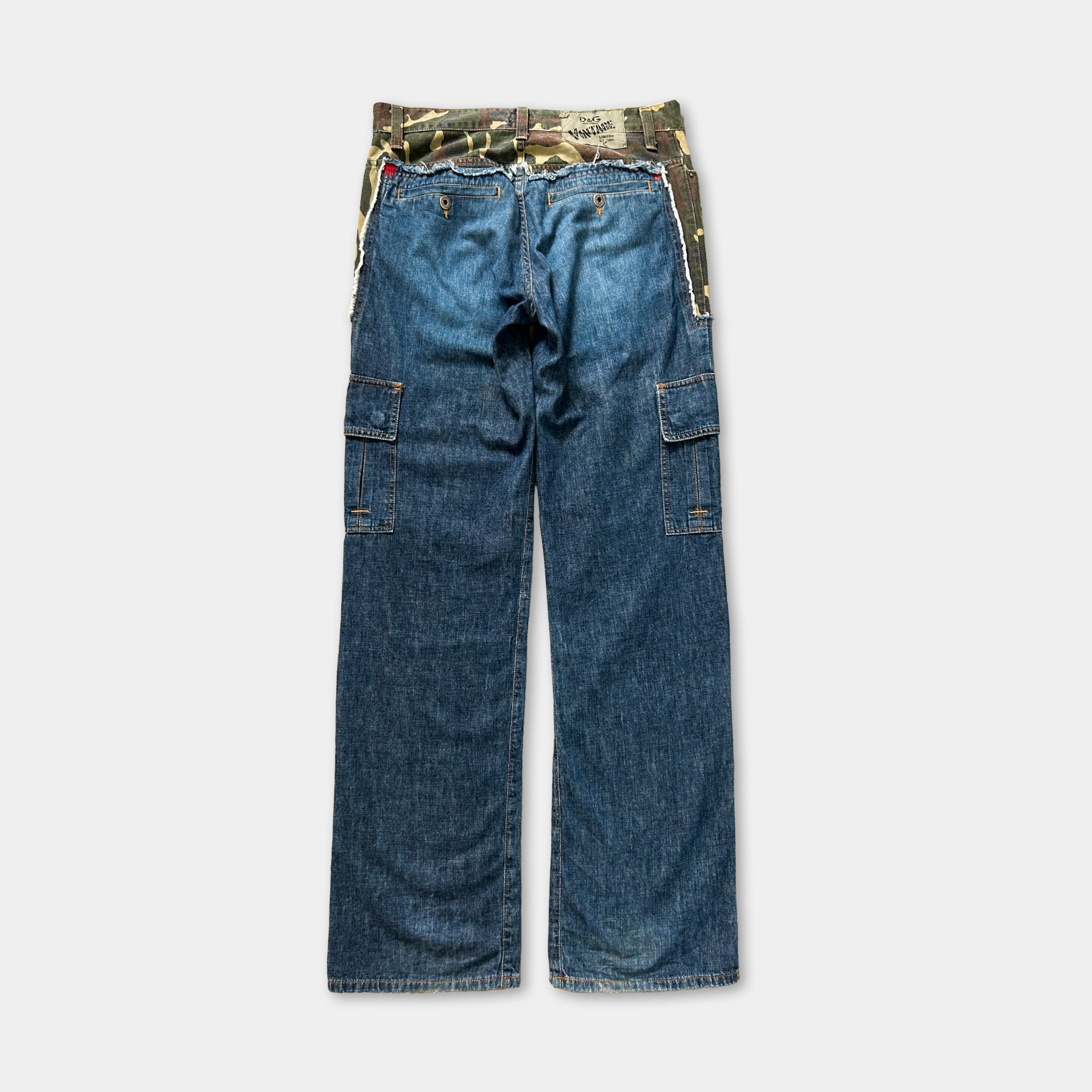 A pair of blue jeans with a camouflage pattern on the waistband.