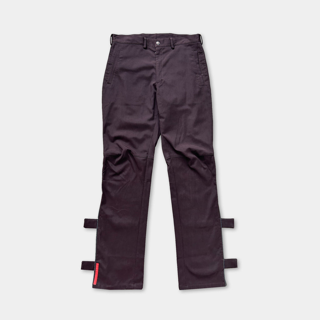 A pair of dark purple cargo pants with a red tag on the left leg.