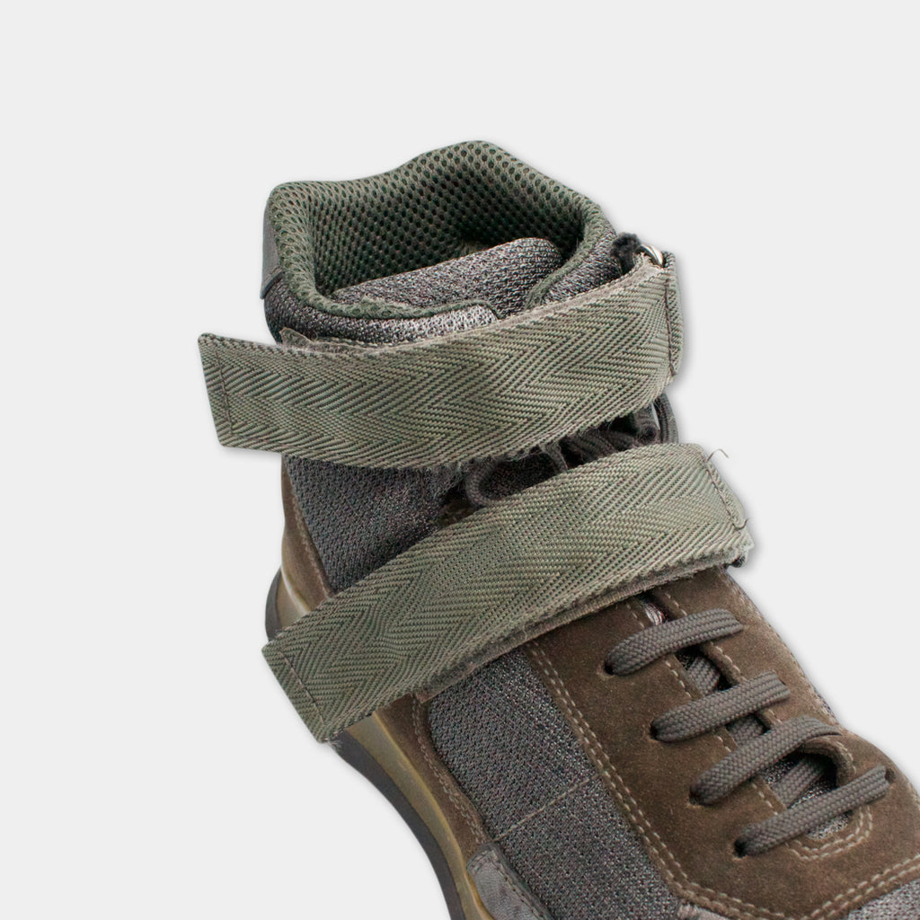 A close-up view of a brown and gray high-top sneaker with a herringbone pattern on the upper part.