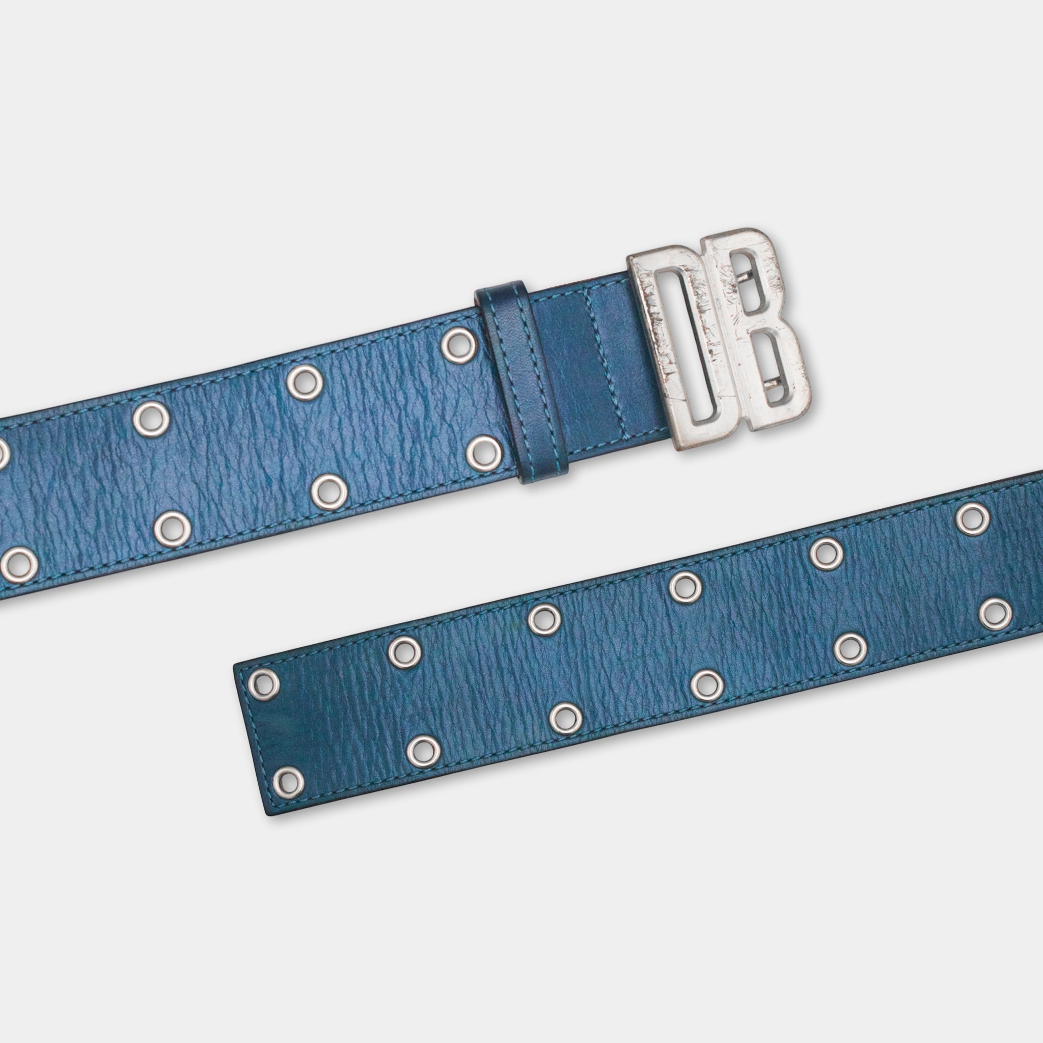 A blue leather belt with silver studs and a metal buckle.