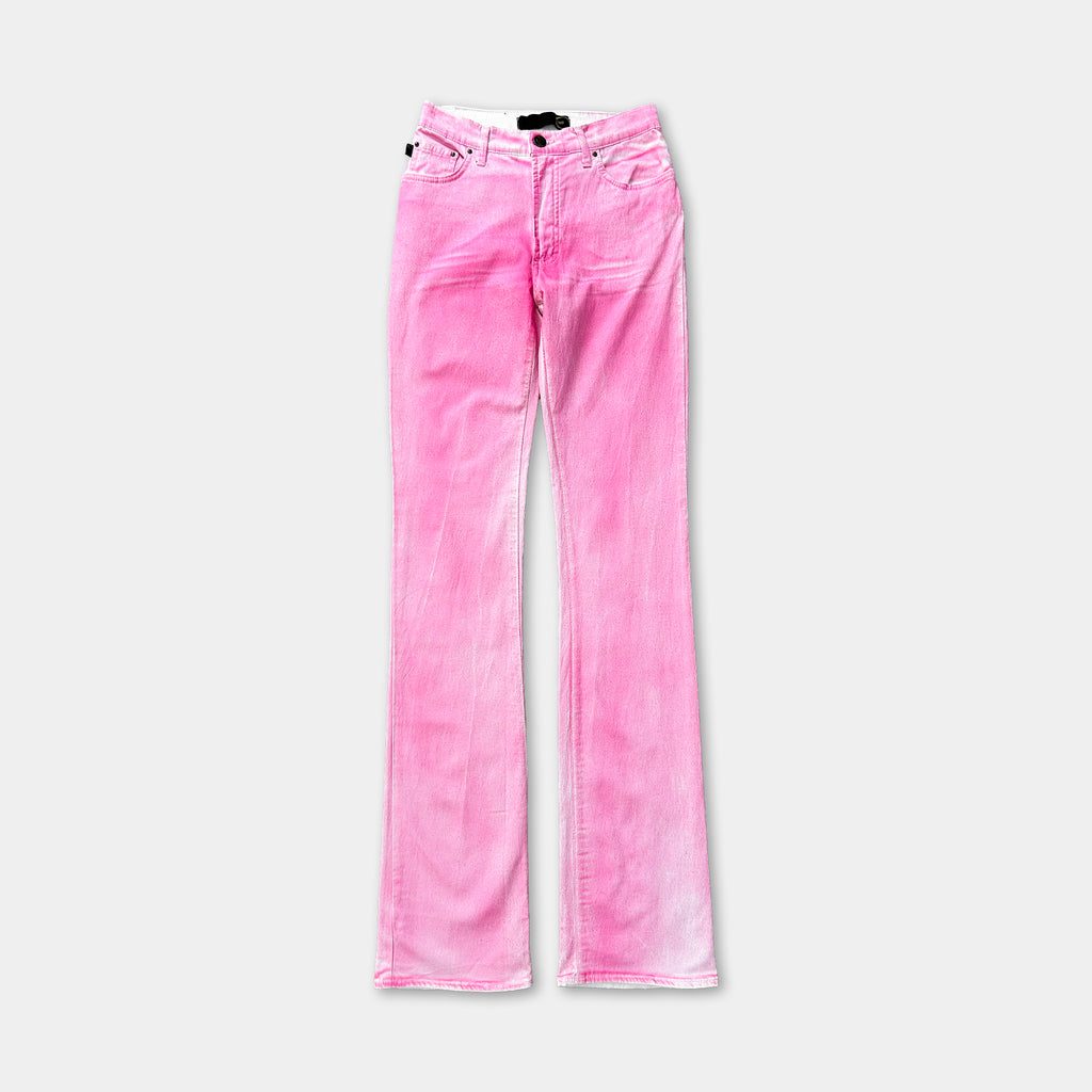 A pair of pink jeans with a black label on the waistband.
