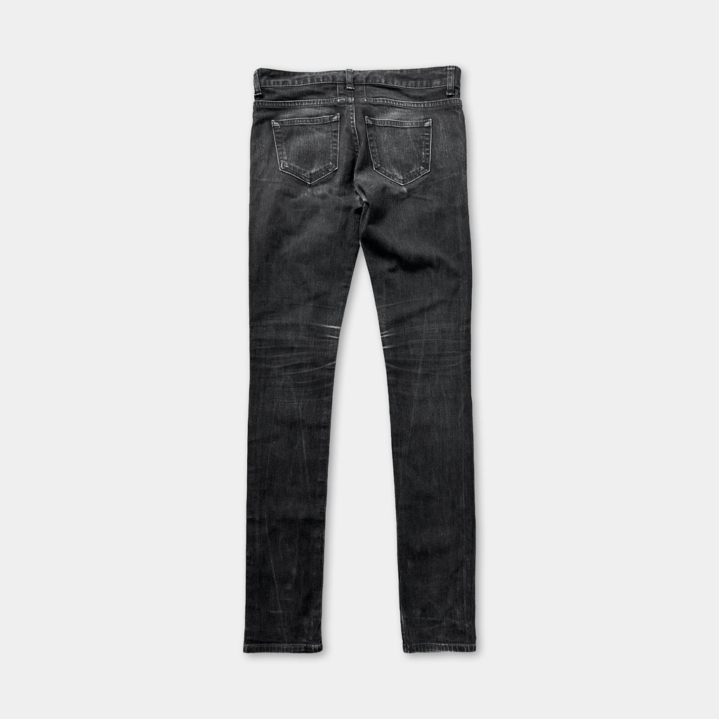 A pair of black skinny jeans with a classic fit and a slightly distressed appearance.