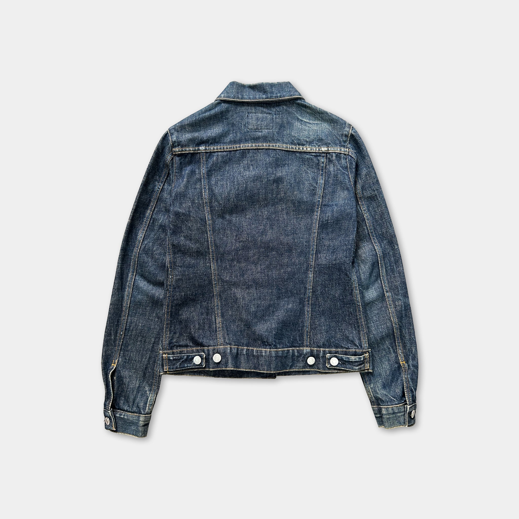 A denim jacket is shown against a white background.