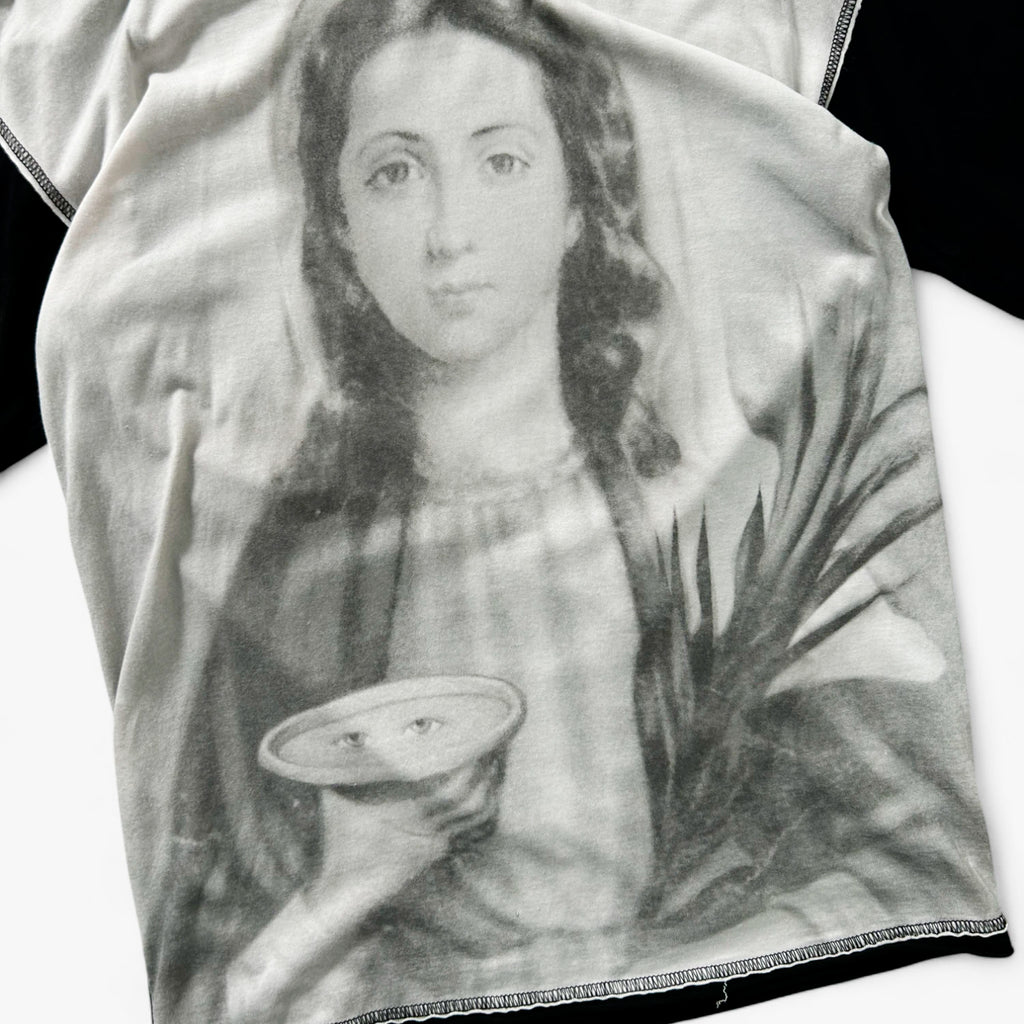 a black and white portrait of a woman holding a plate with a face on it.