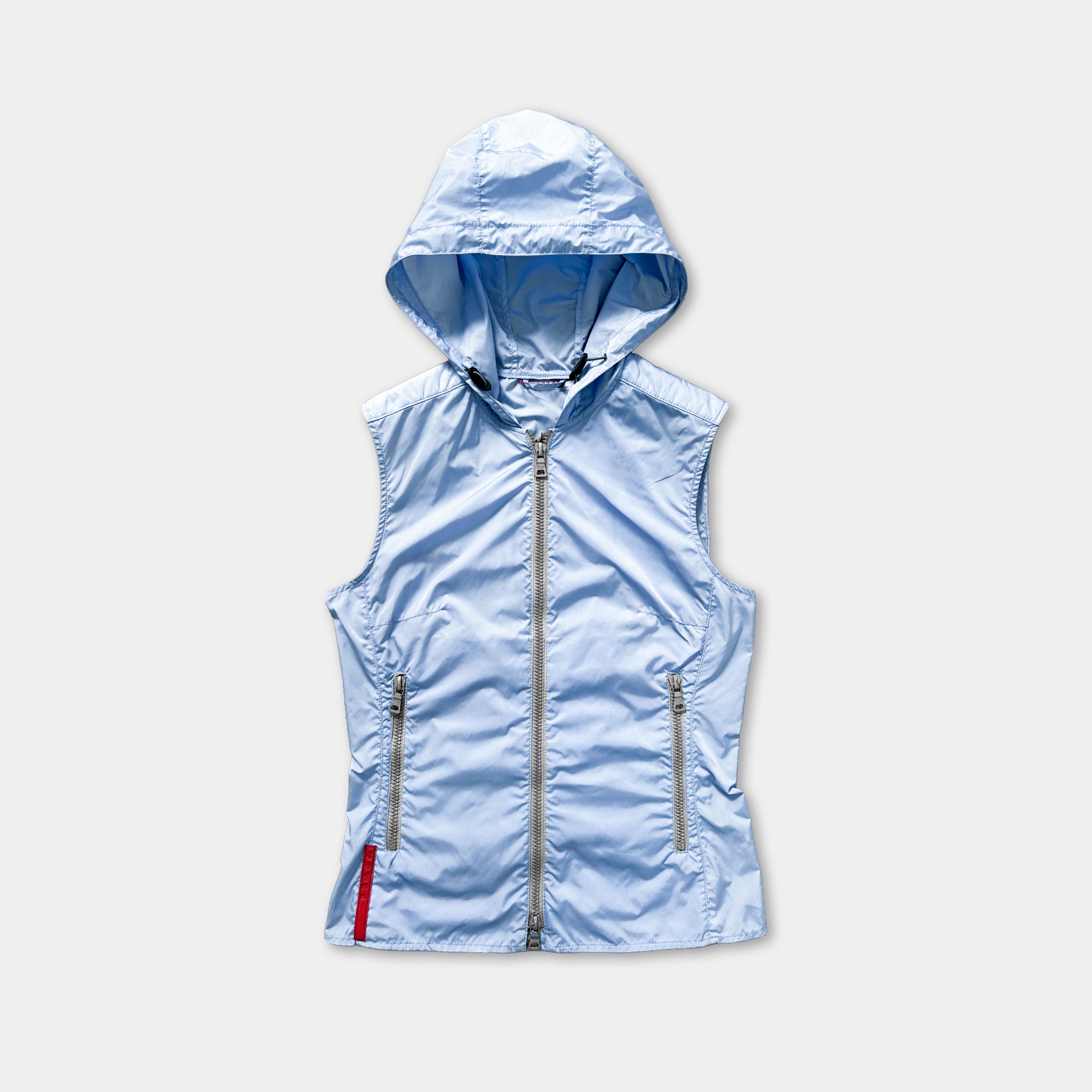 A light blue hooded vest with a zipper and pockets, displayed against a plain white background.