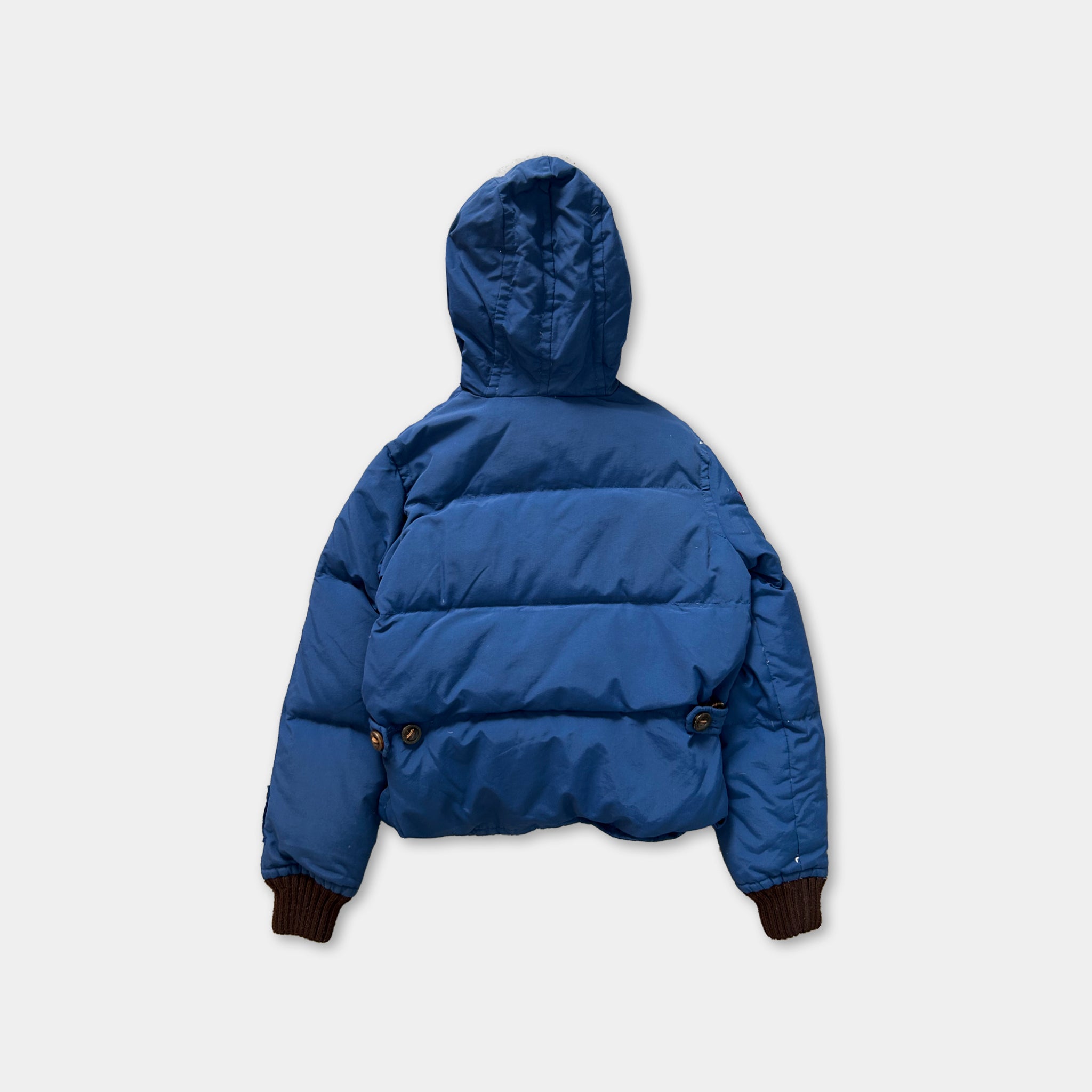 A blue puffy jacket with a hood, displayed against a white background.
