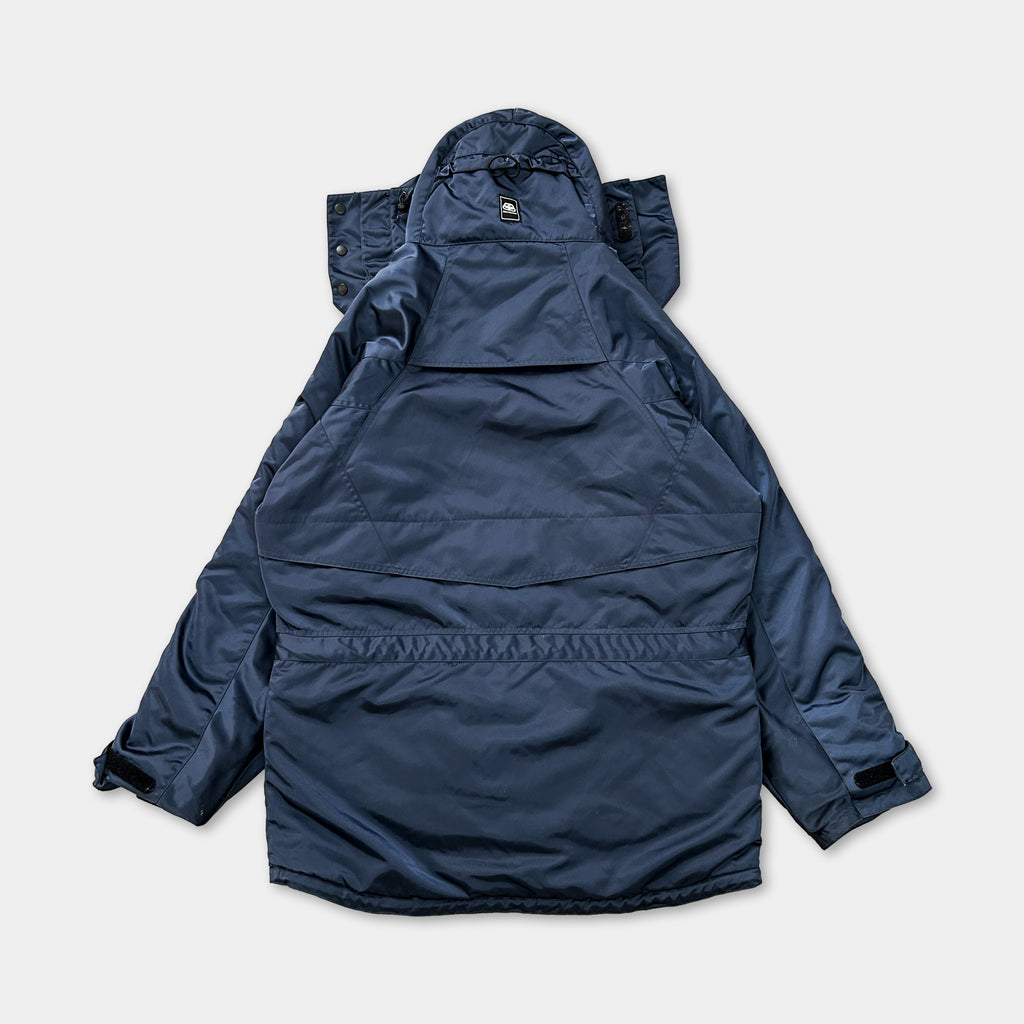 A navy blue parka jacket is shown in the image, with the hood and zipper visible.