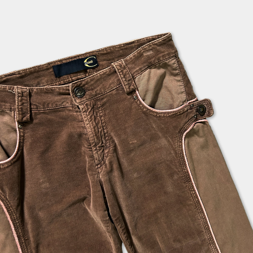A pair of brown corduroy pants with a zipper detail and a black belt loop.