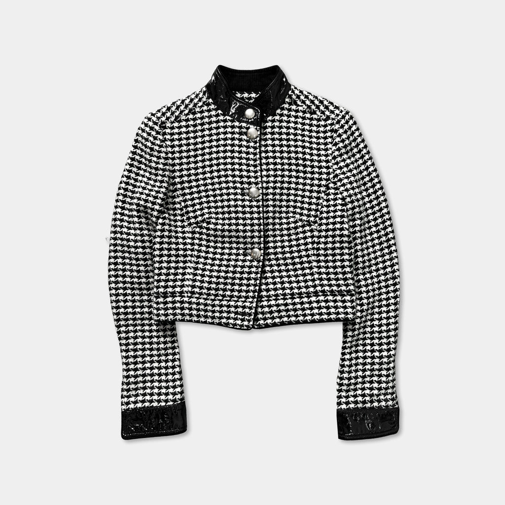 A black and white checkered jacket with a collar and buttons, displayed against a plain background.