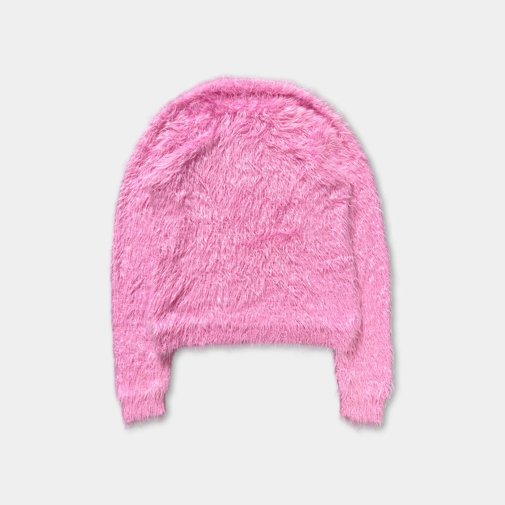 A pink fuzzy sweater is shown against a white background.