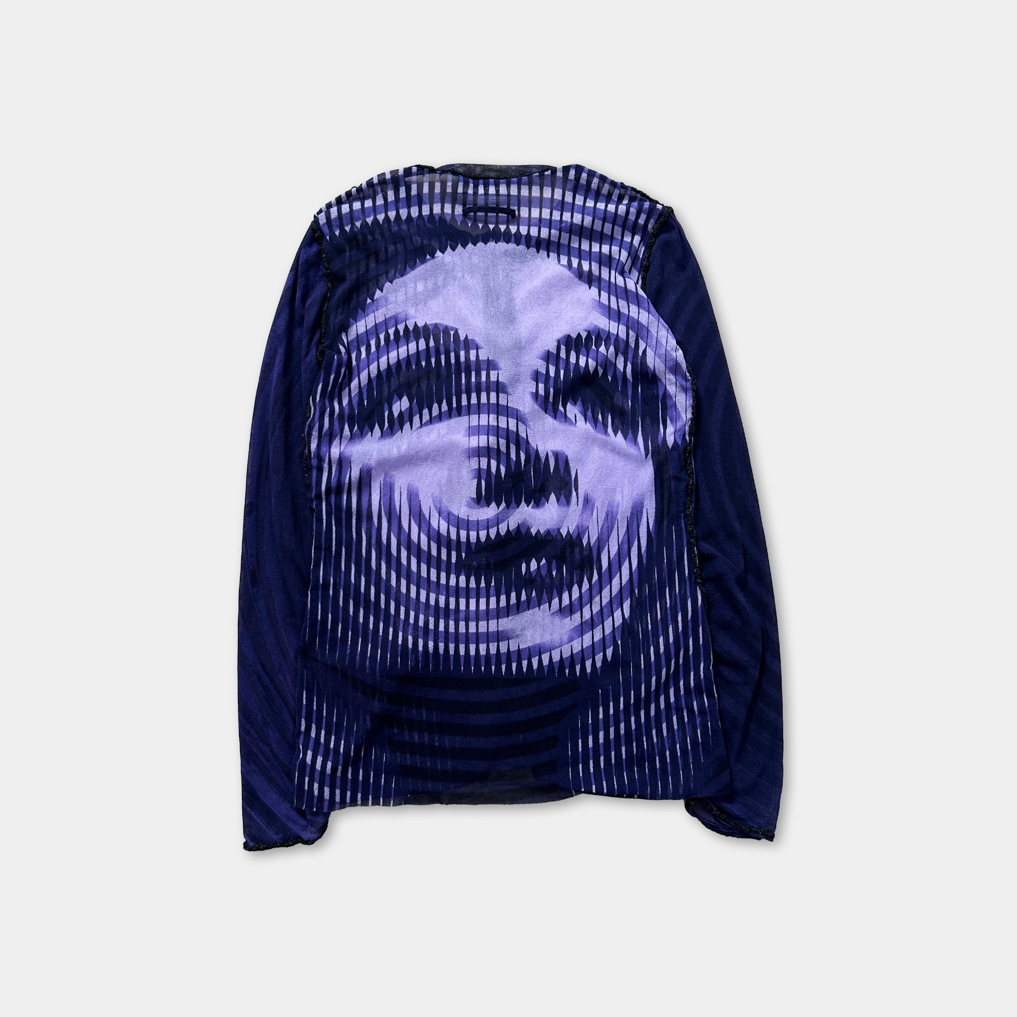a long-sleeved shirt with a striking graphic design on the back. The design is a close-up of a face, with a pattern of white and blue lines that create a swirling, abstract effect. The shirt appears to be a dark-colored garment, possibly a long-sleeved shirt or a jacket.
