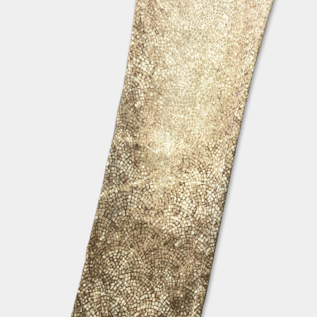 a close-up view of a textured fabric or material with a mosaic pattern, possibly a tie or a piece of clothing.