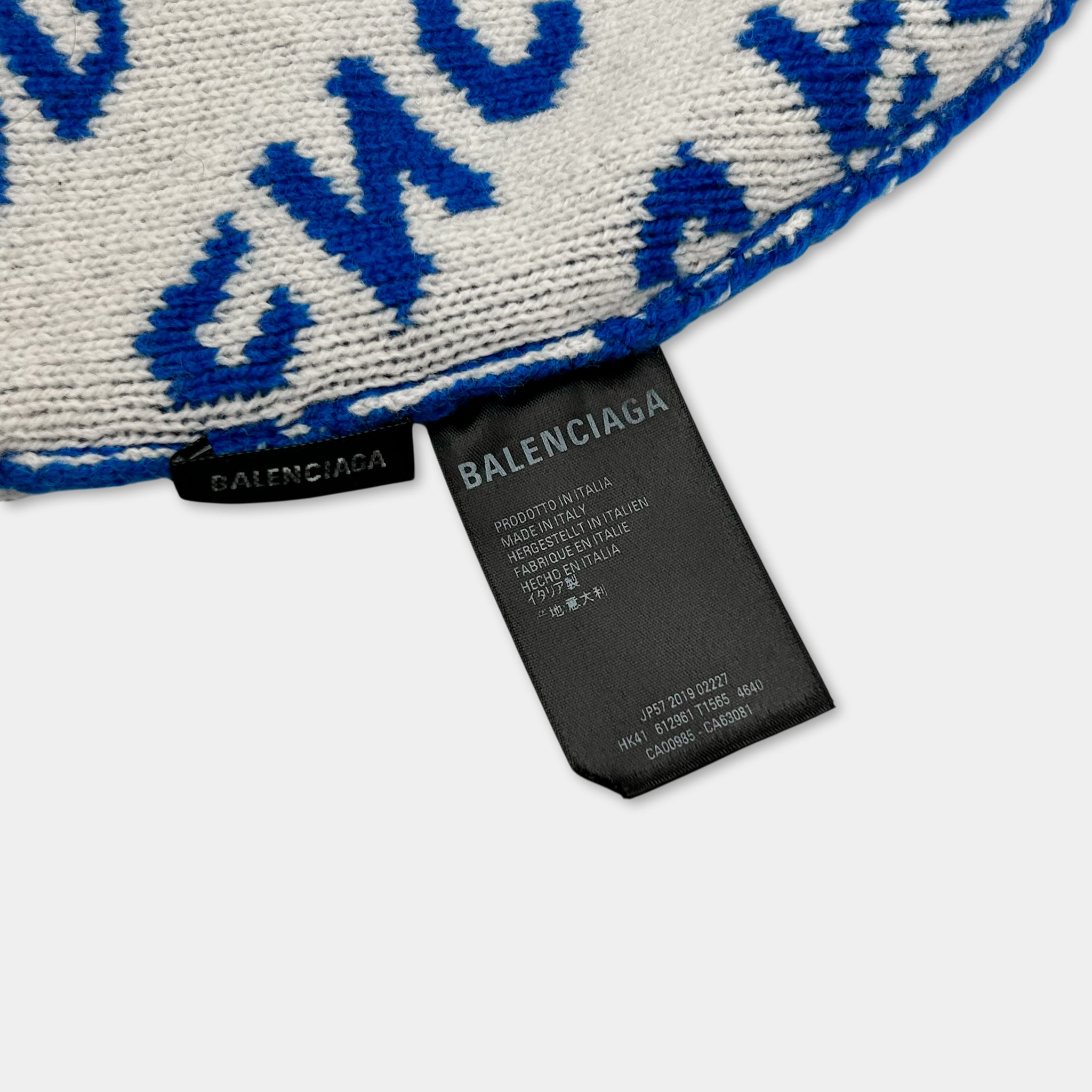 A close-up view of a black label with text on it, placed on a white surface.