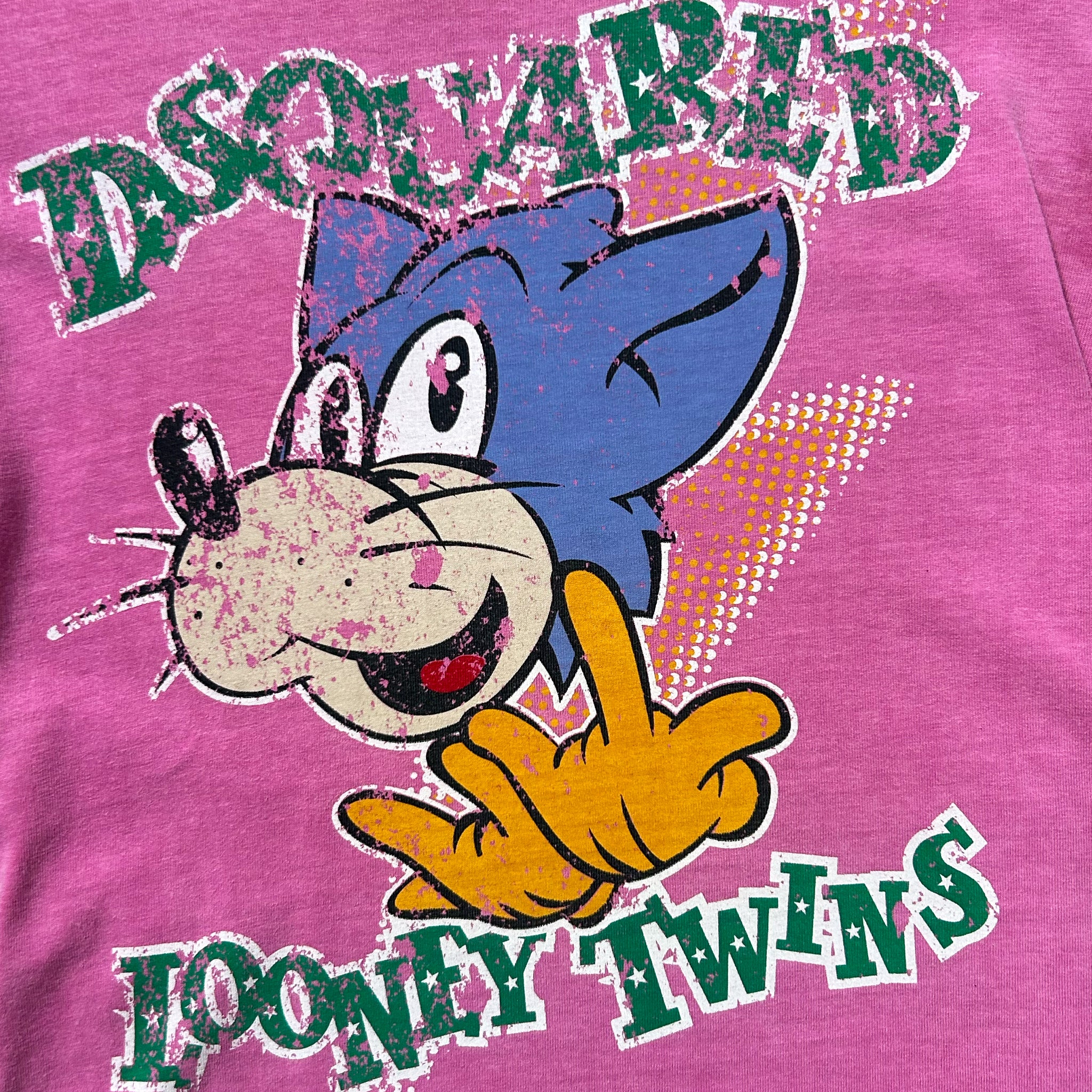 A pink t-shirt with a cartoon image of a cat and the text "Looney Twins" printed on it.