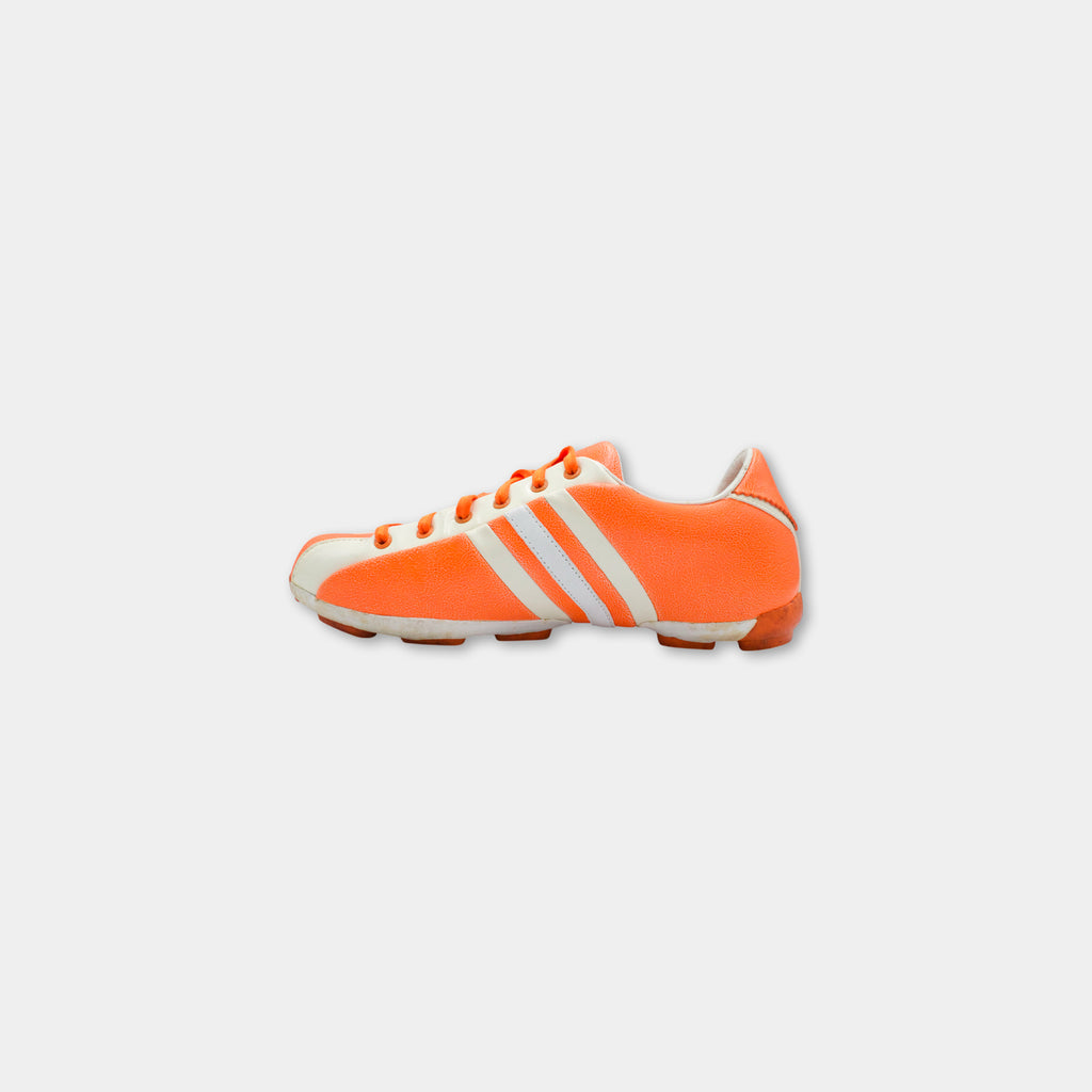 A single orange and white Adidas sneaker is shown against a plain white background.