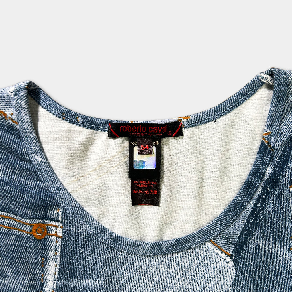 a close-up view of a blue denim-like fabric, possibly a shirt or blouse, with a label attached to it.