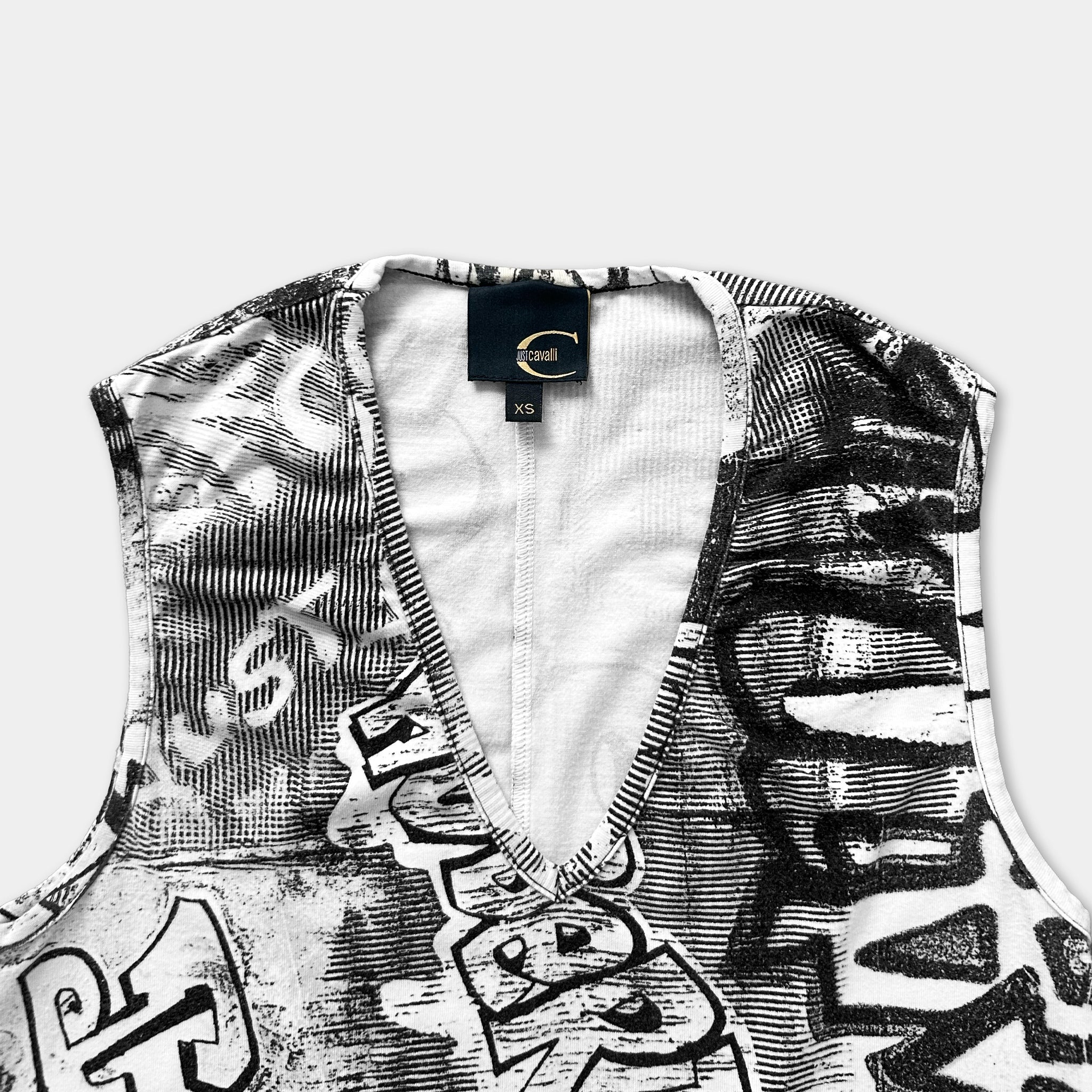a close-up view of a sleeveless top with a black and white printed pattern.