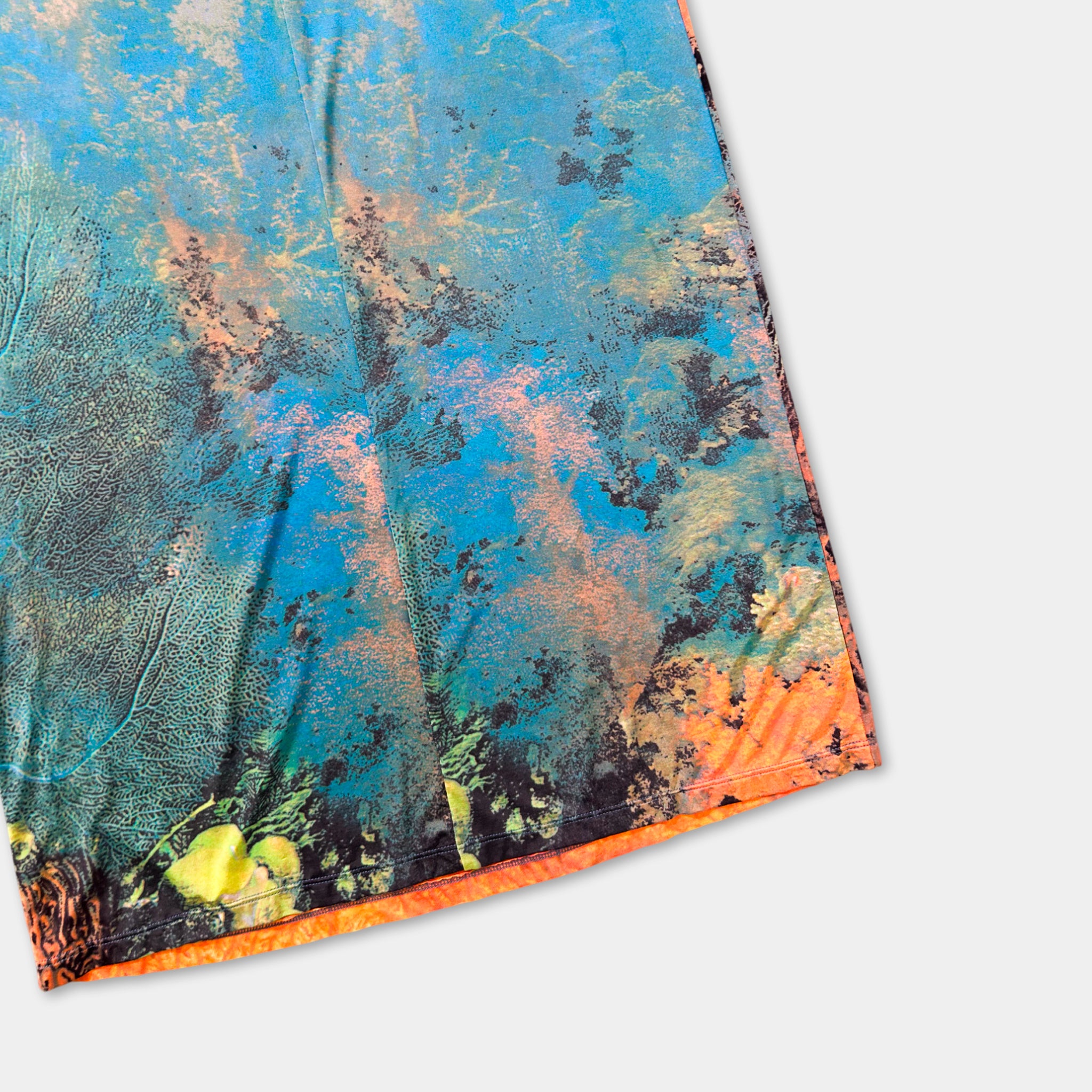 a vibrant, abstract pattern with a mix of blue, orange, and green colors, resembling a painting or a textile design.