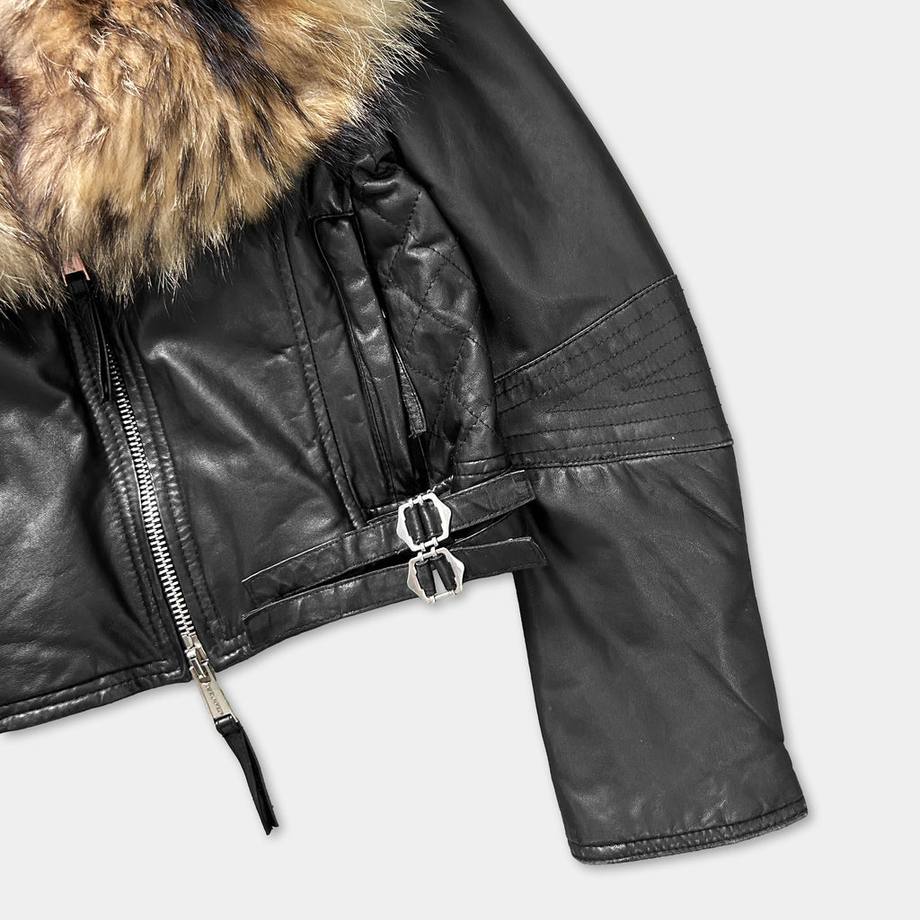 A close-up view of a black leather jacket with a fur collar.
