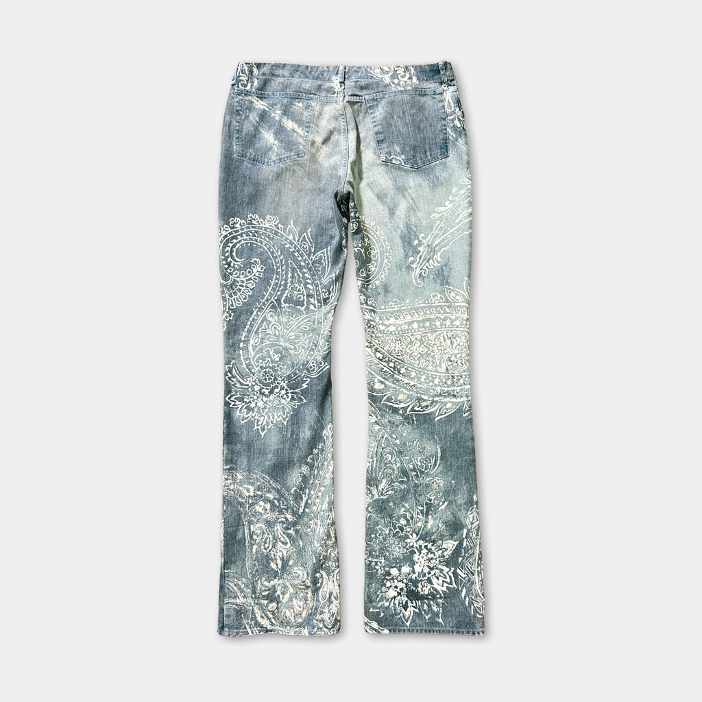 A pair of blue jeans with a paisley pattern printed on them.