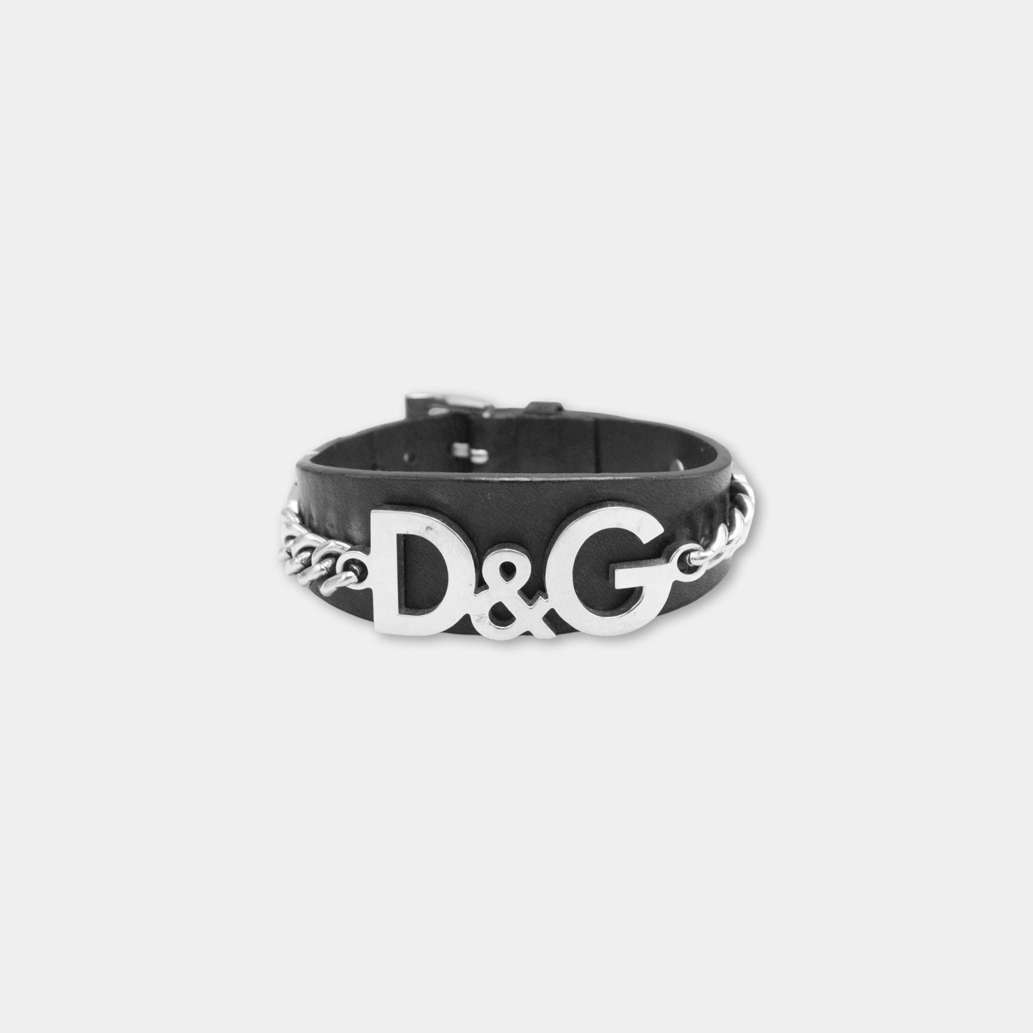 A black leather bracelet with the letters 'D&G' prominently displayed in the center.