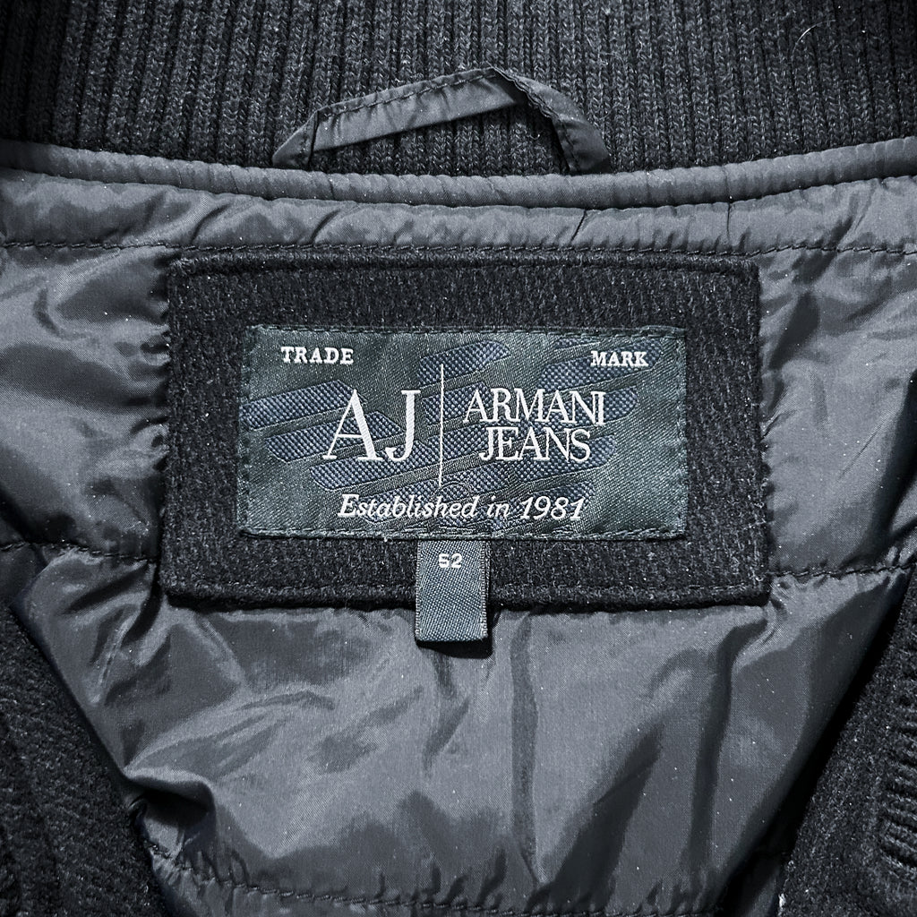 a close-up view of a black jacket with a label that displays the brand name and establishment year.