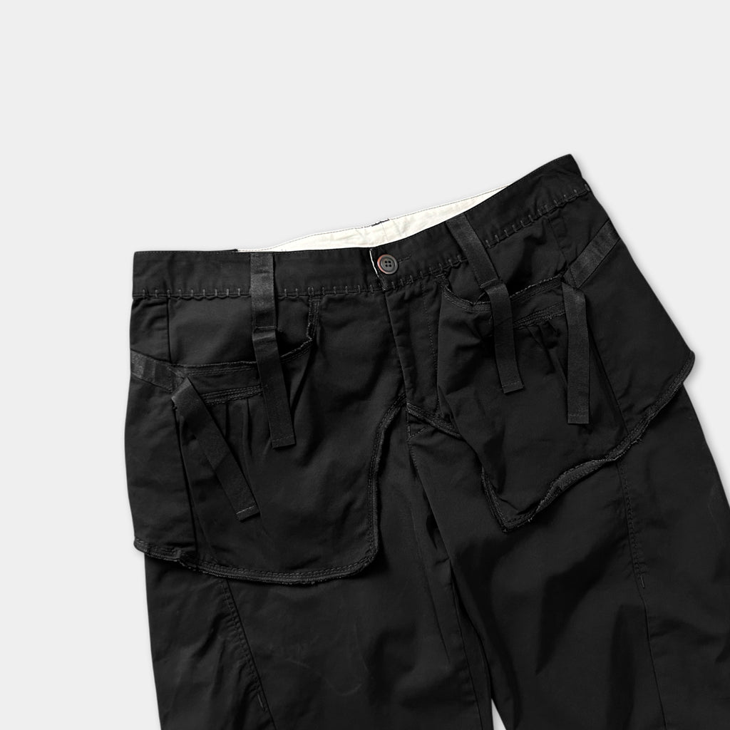 A pair of black cargo shorts with multiple pockets and a button waistband.