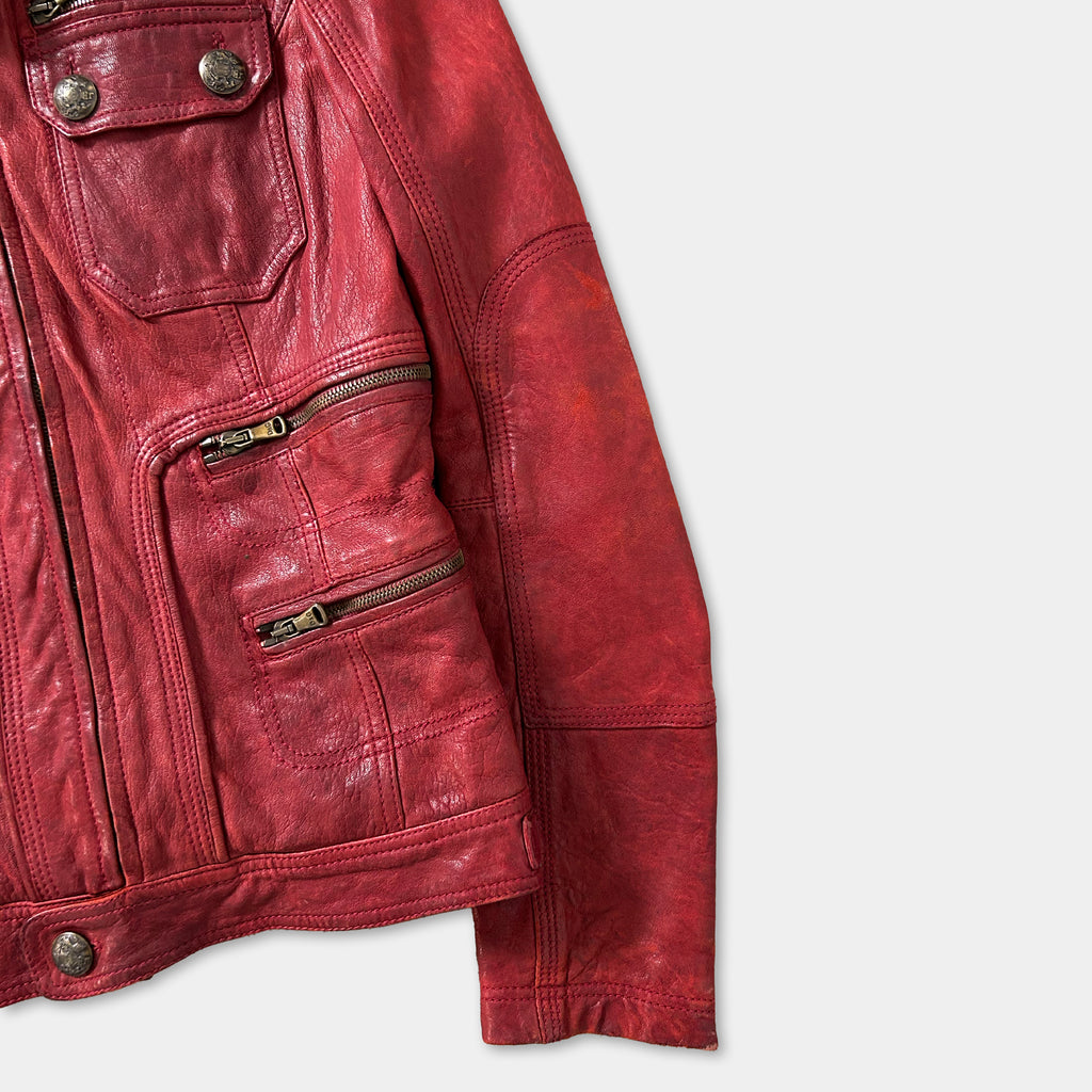 A red leather jacket with multiple pockets and zippers, displayed against a white background.