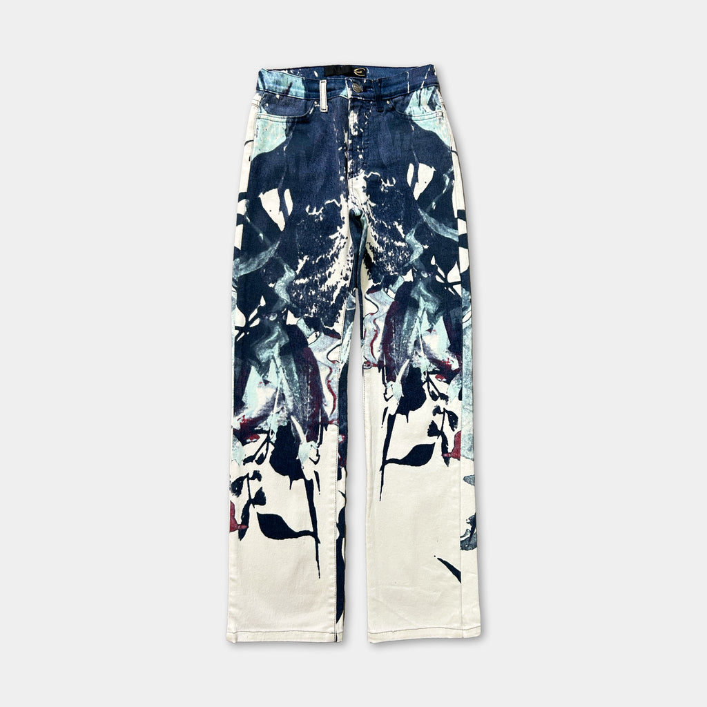 A pair of blue jeans with a floral print design on the front.