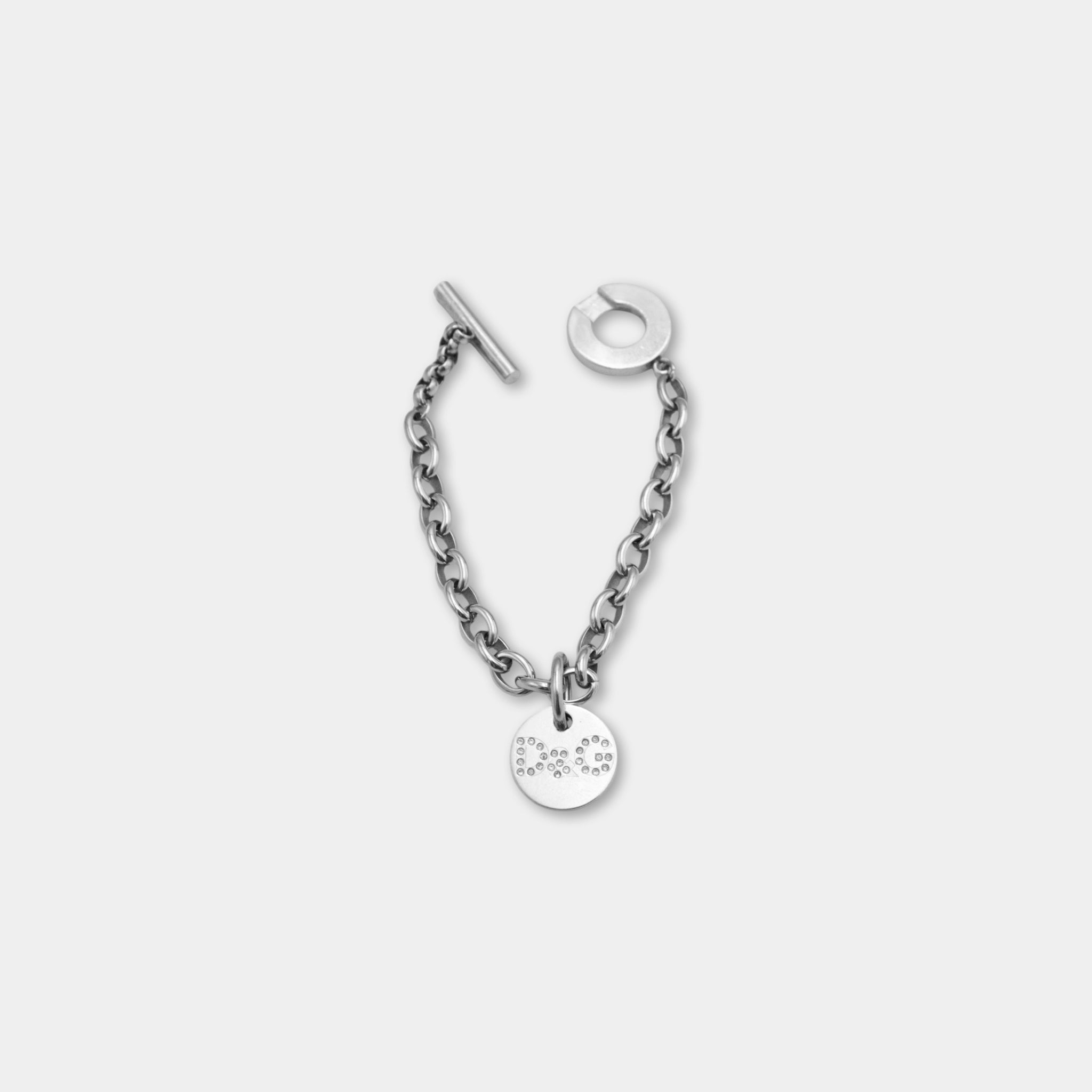 A silver-colored chain bracelet with a small circular charm attached to it.