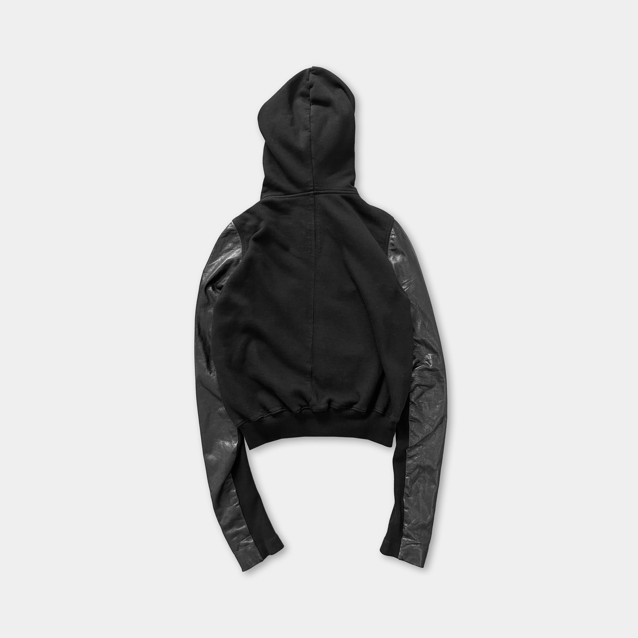 A black hooded sweatshirt with long sleeves and a hood.