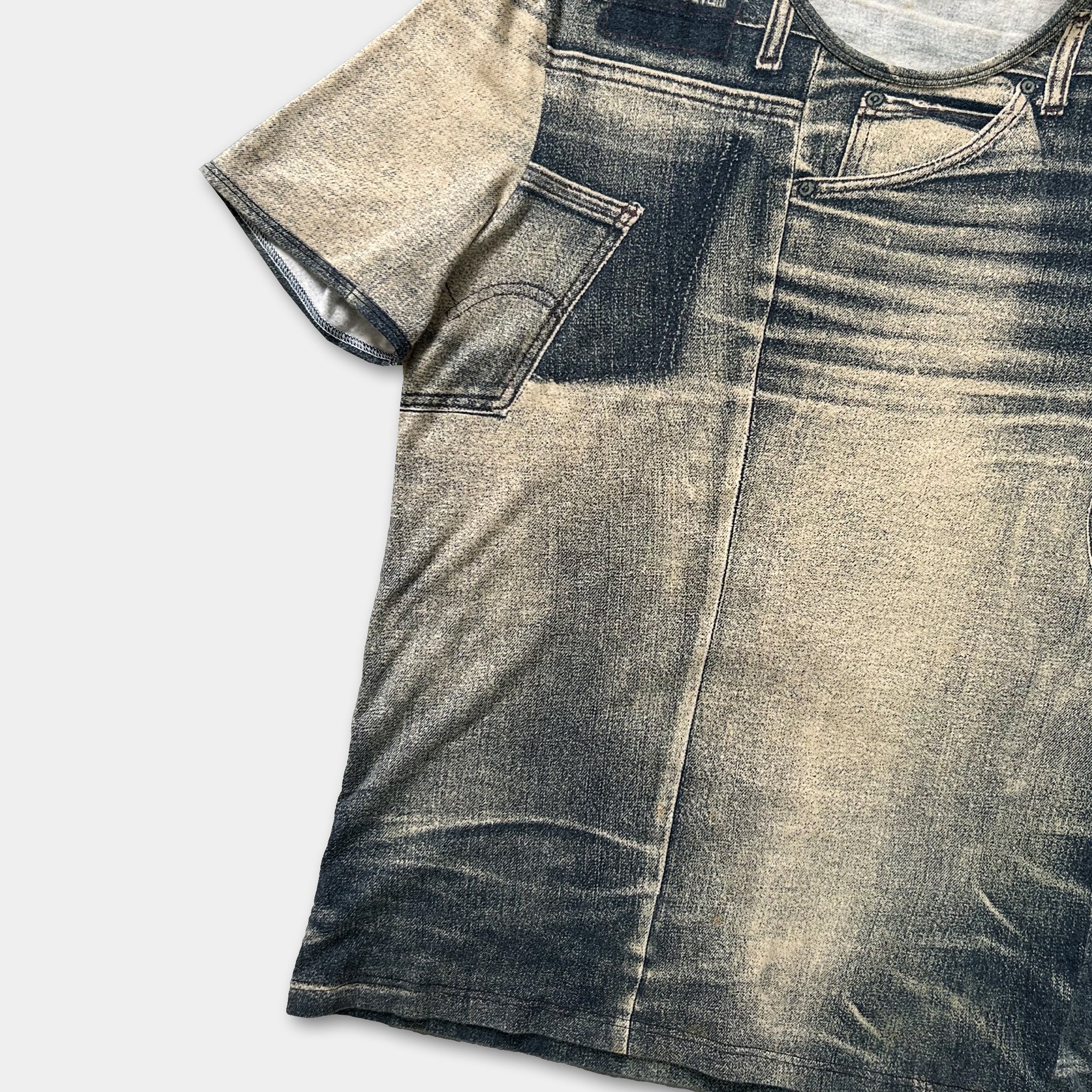 a t-shirt with a printed design of a pair of jeans, featuring a distressed and faded appearance.