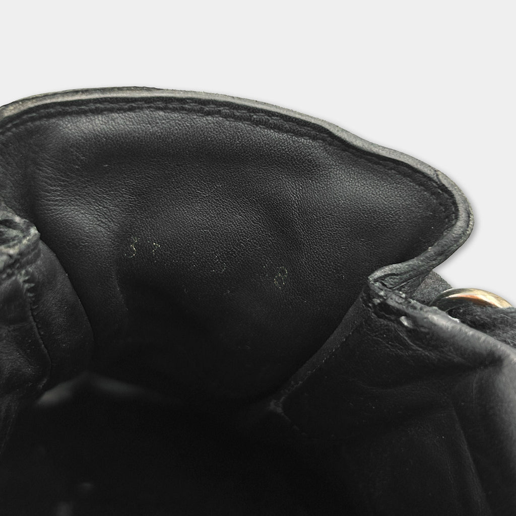 the interior of a black leather shoe, specifically the sole and the interior of the shoe.