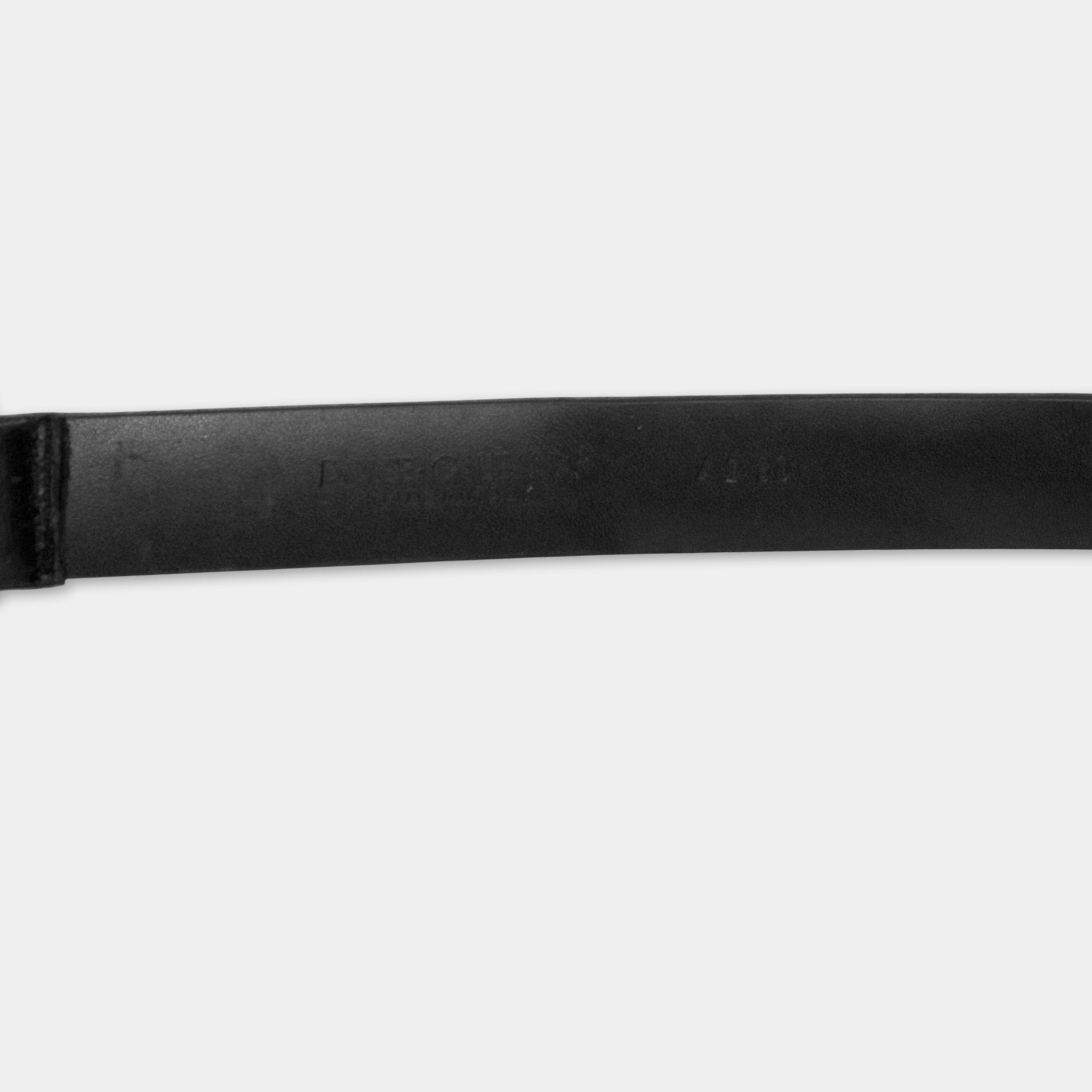A close-up view of a black leather belt against a white background.