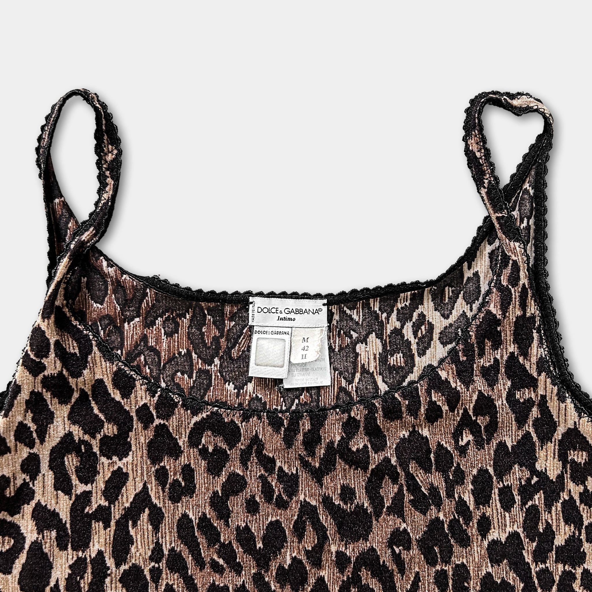 A leopard print tank top with a label on the collar.