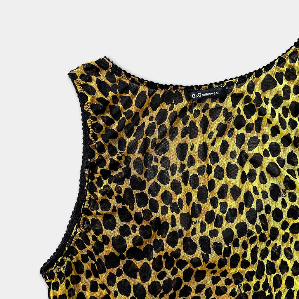A close-up view of a leopard print dress or top, with a label indicating it is a Dior Underwear product.