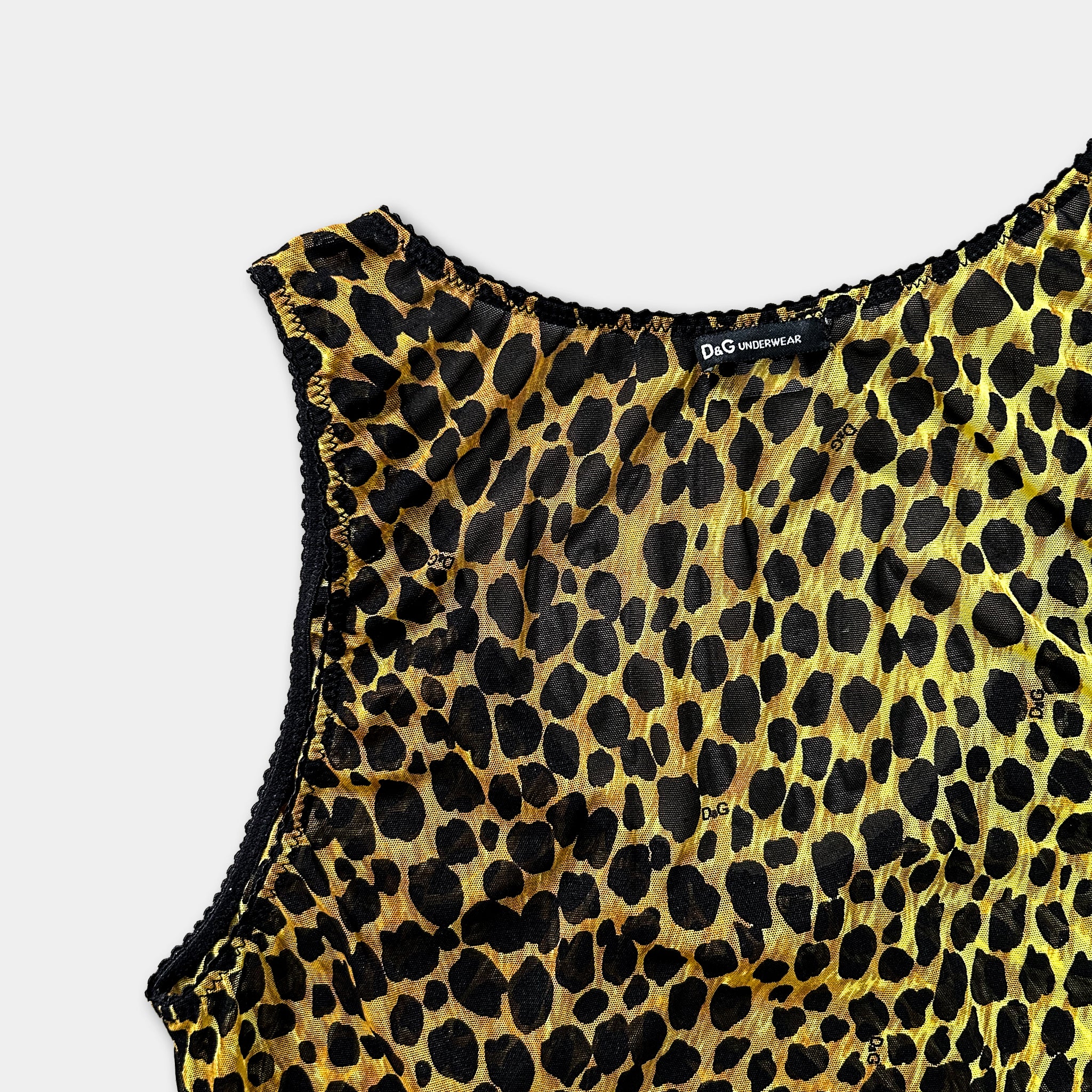 A close-up view of a leopard print dress or top, with a label indicating it is a Dior Underwear product.