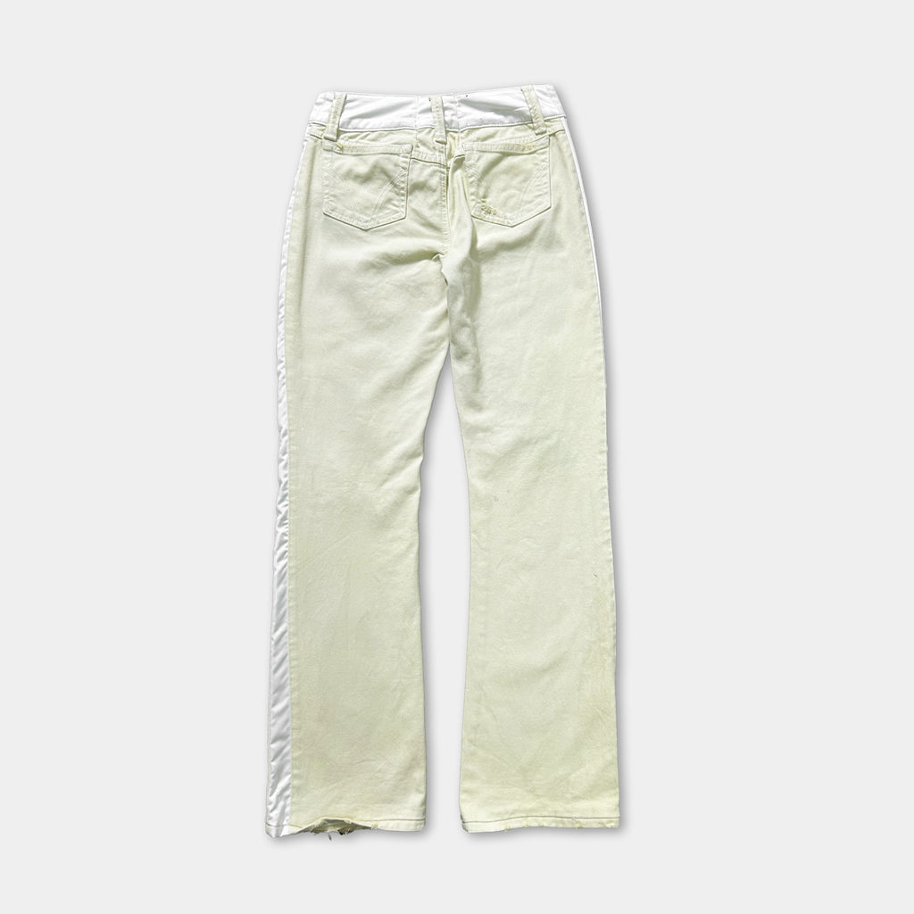 A pair of white jeans with a white stripe down the side.