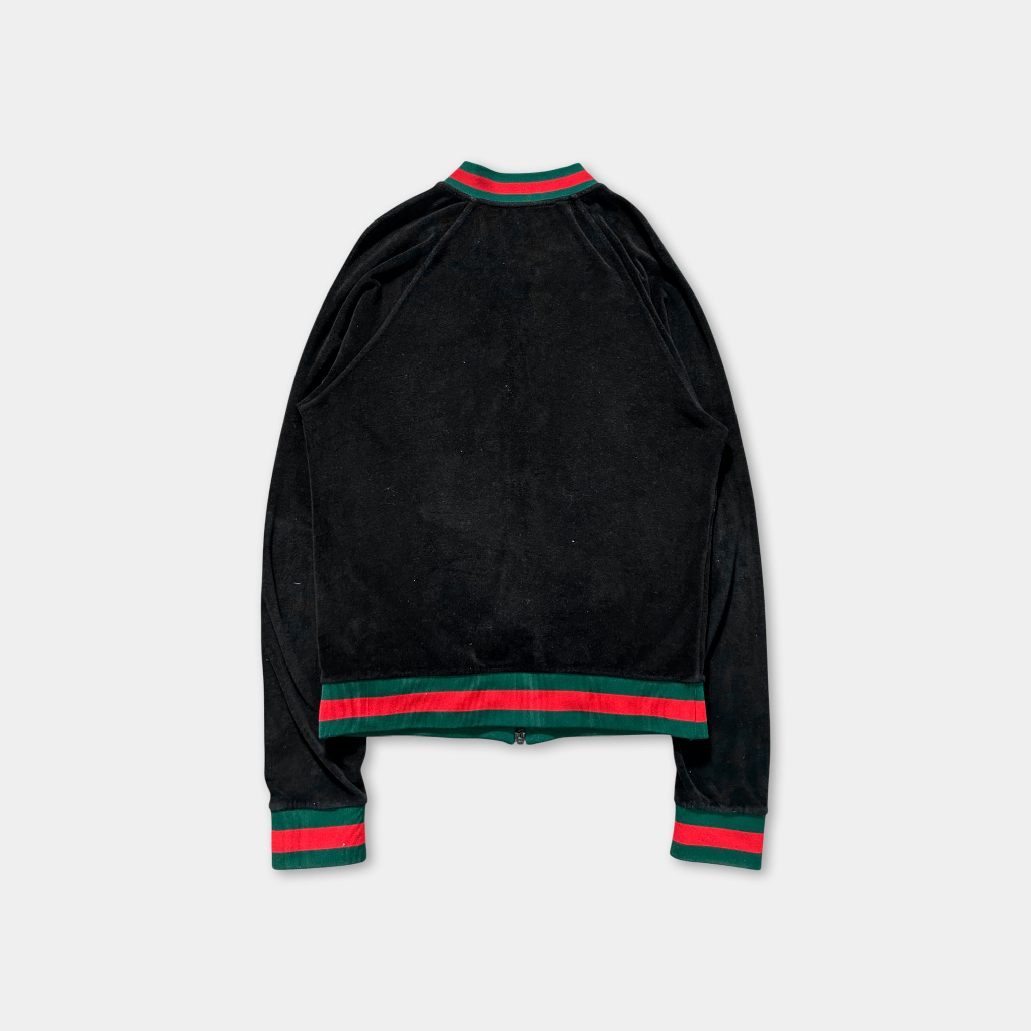 A black velvet jacket with red and green stripes on the sleeves and collar.